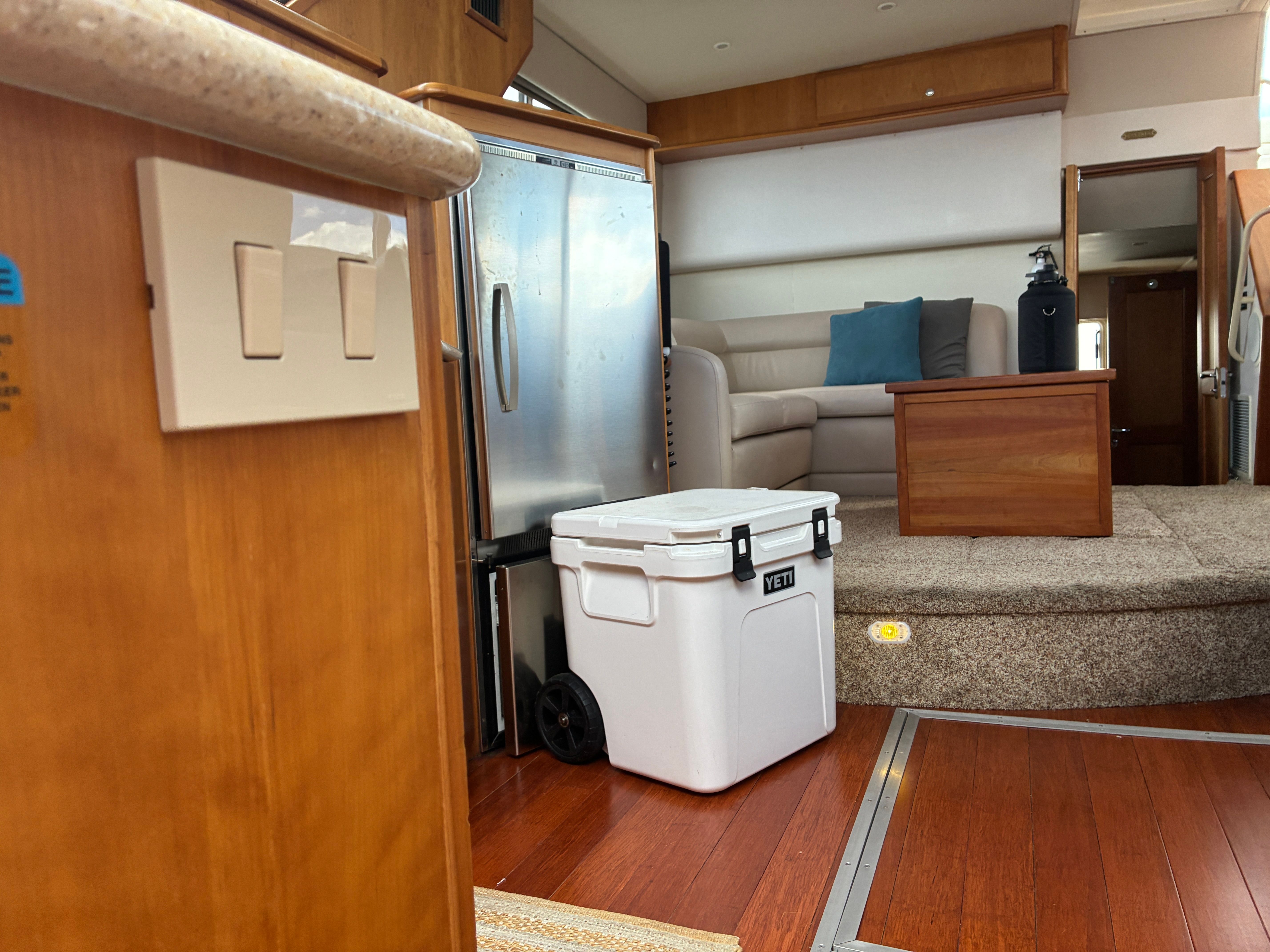 Interior of a 2001 Silverton 392 Motor Yacht with wooden flooring and a cozy seating area.