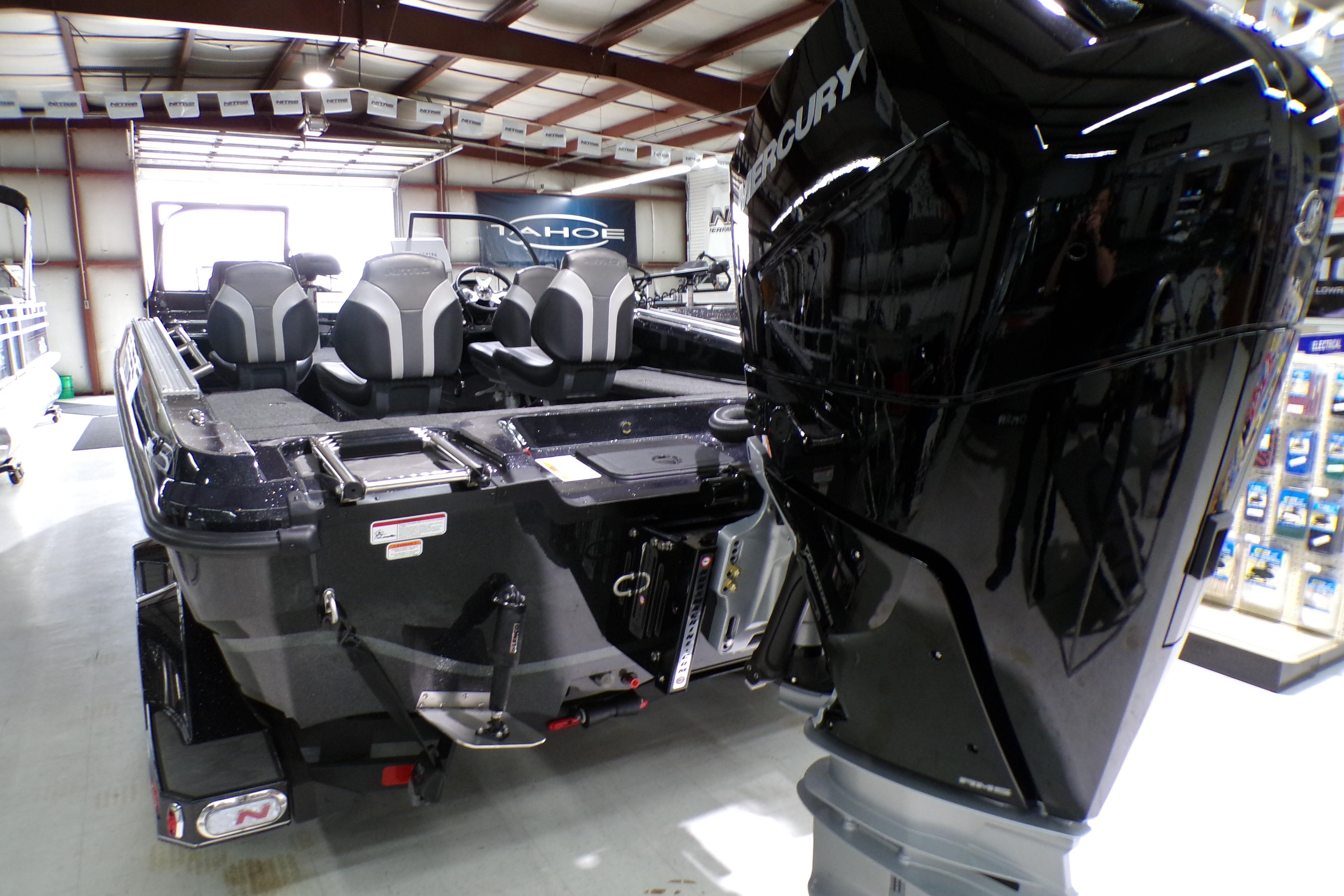 2026 Nitro ZV21 Pro boat with Mercury engine in showroom setting.