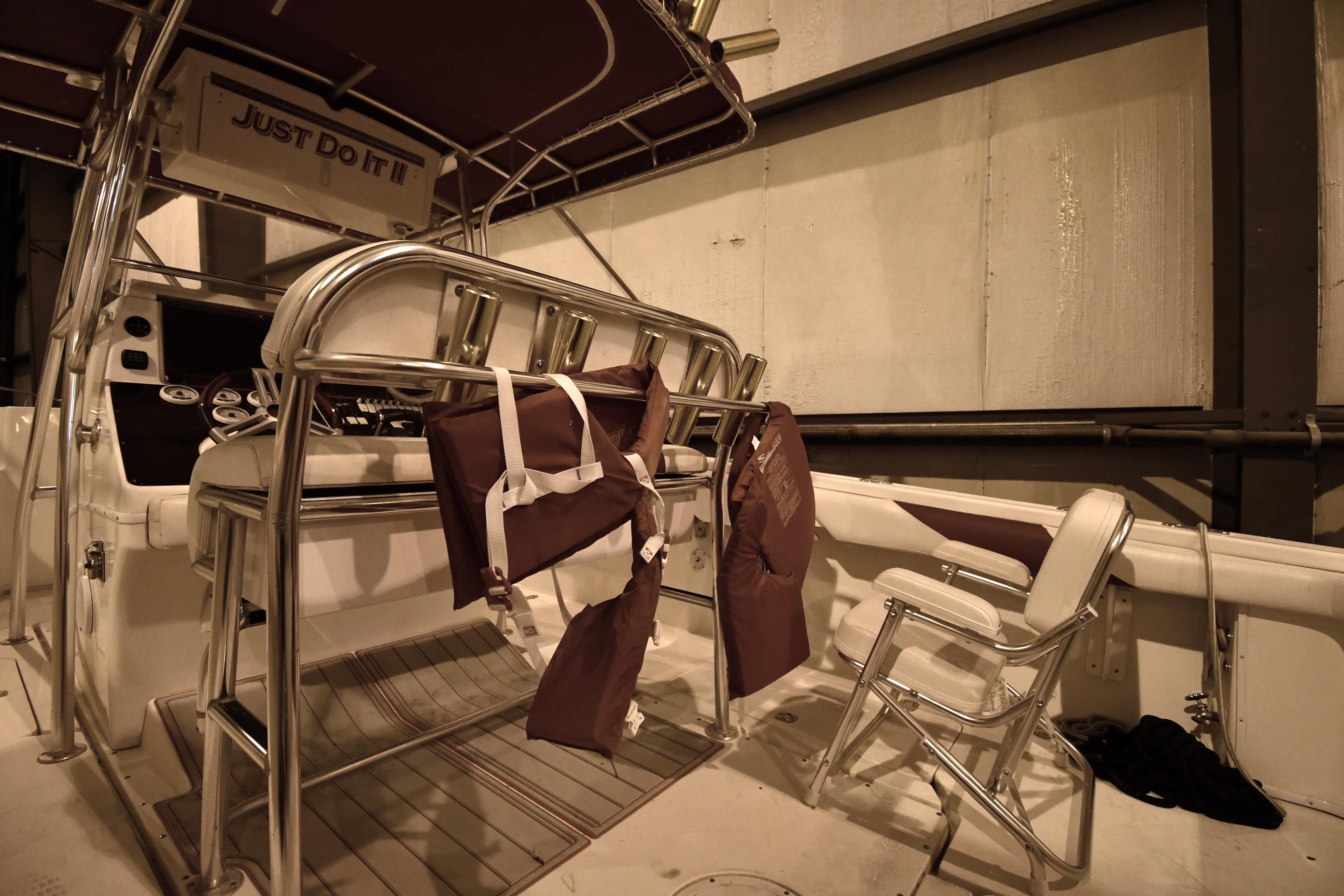 2001 Fountain 38 Center Console boat interior with life jackets and seating.