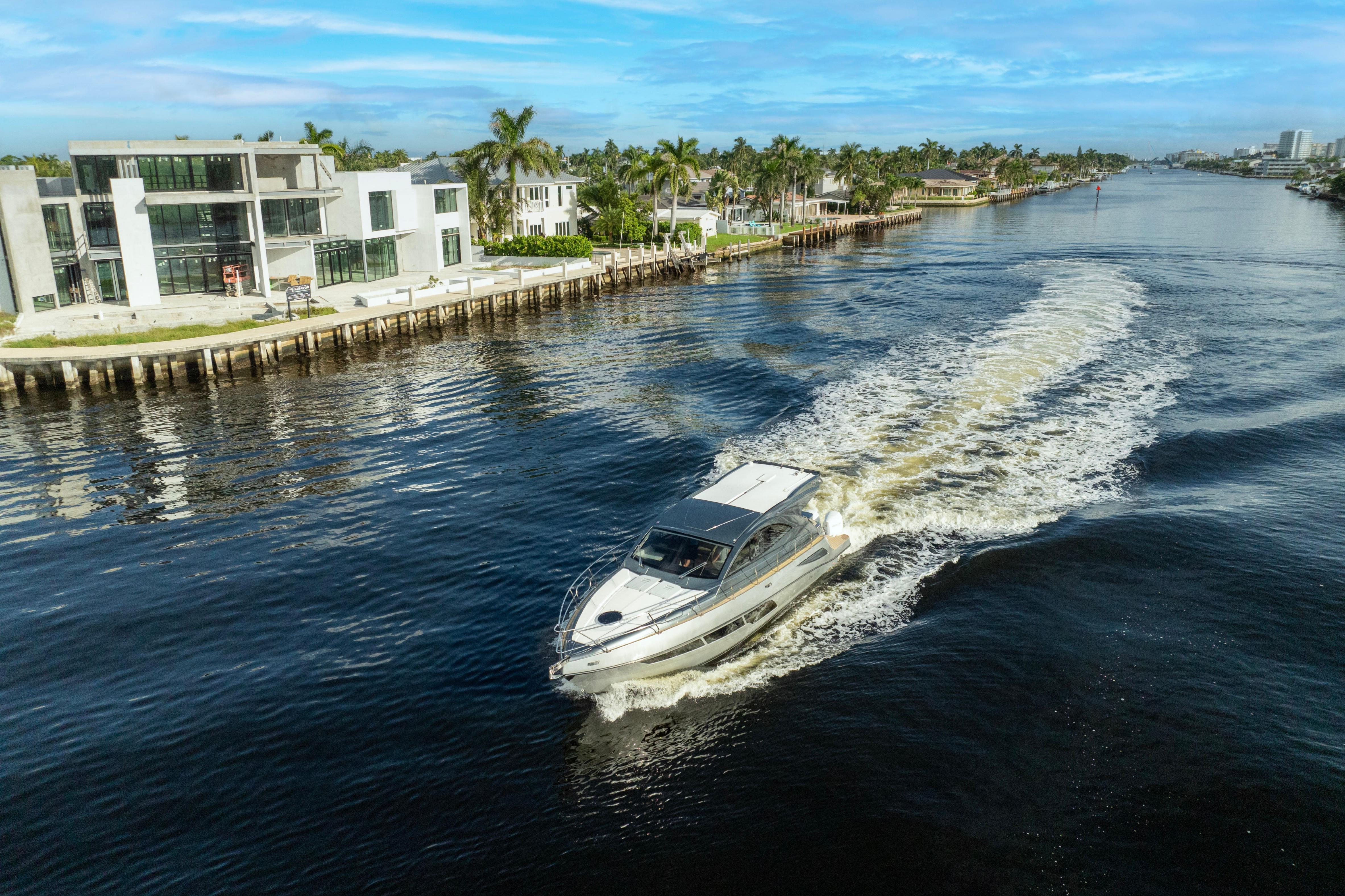 Luxury Valiatt 410HT yacht cruising along a scenic waterfront, 2025 model.