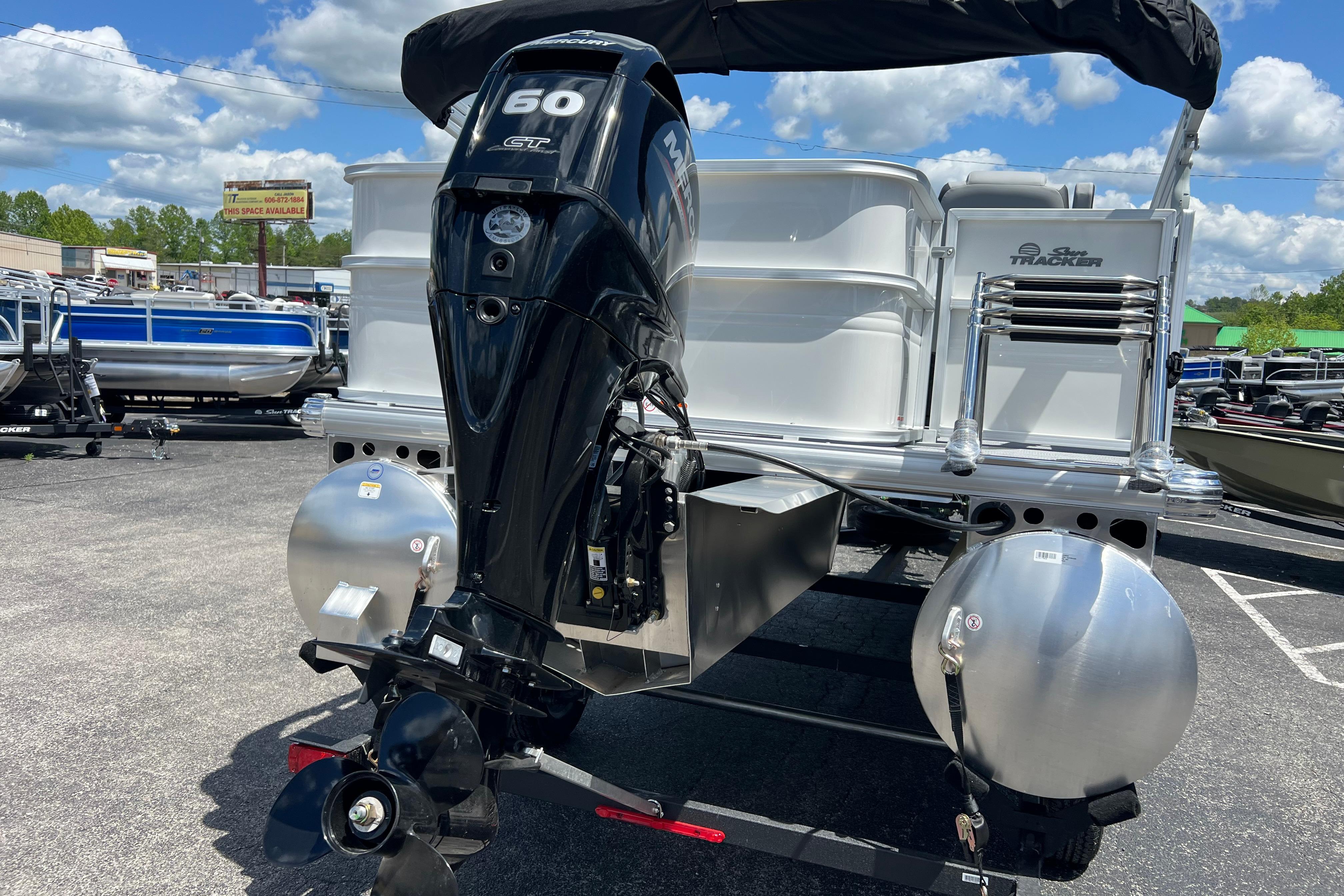 2026 Sun Tracker Party Barge 18 DLX pontoon boat with powerful outboard motor.