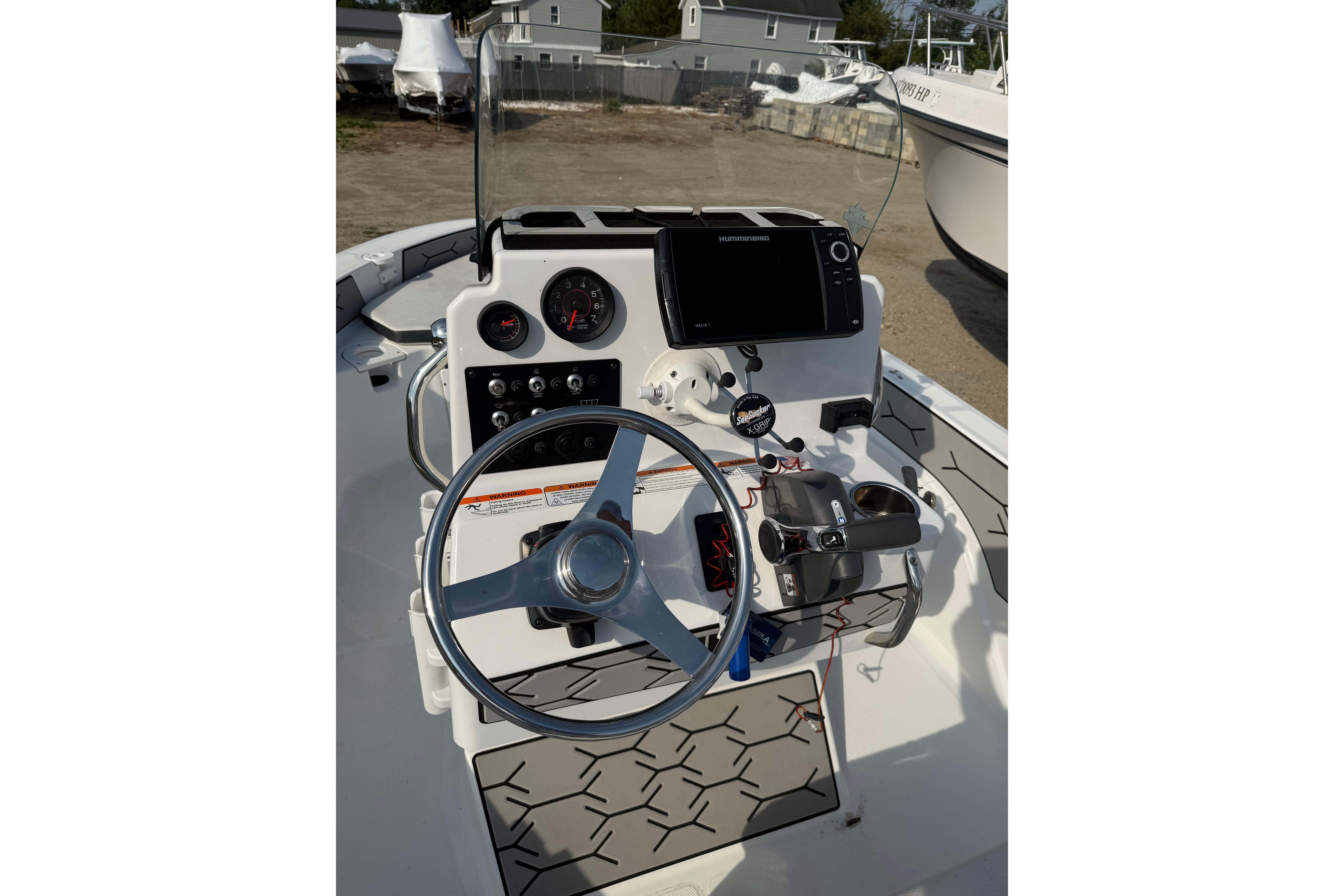 2020 Wellcraft 162 Fisherman boat dashboard with steering wheel and navigation controls.