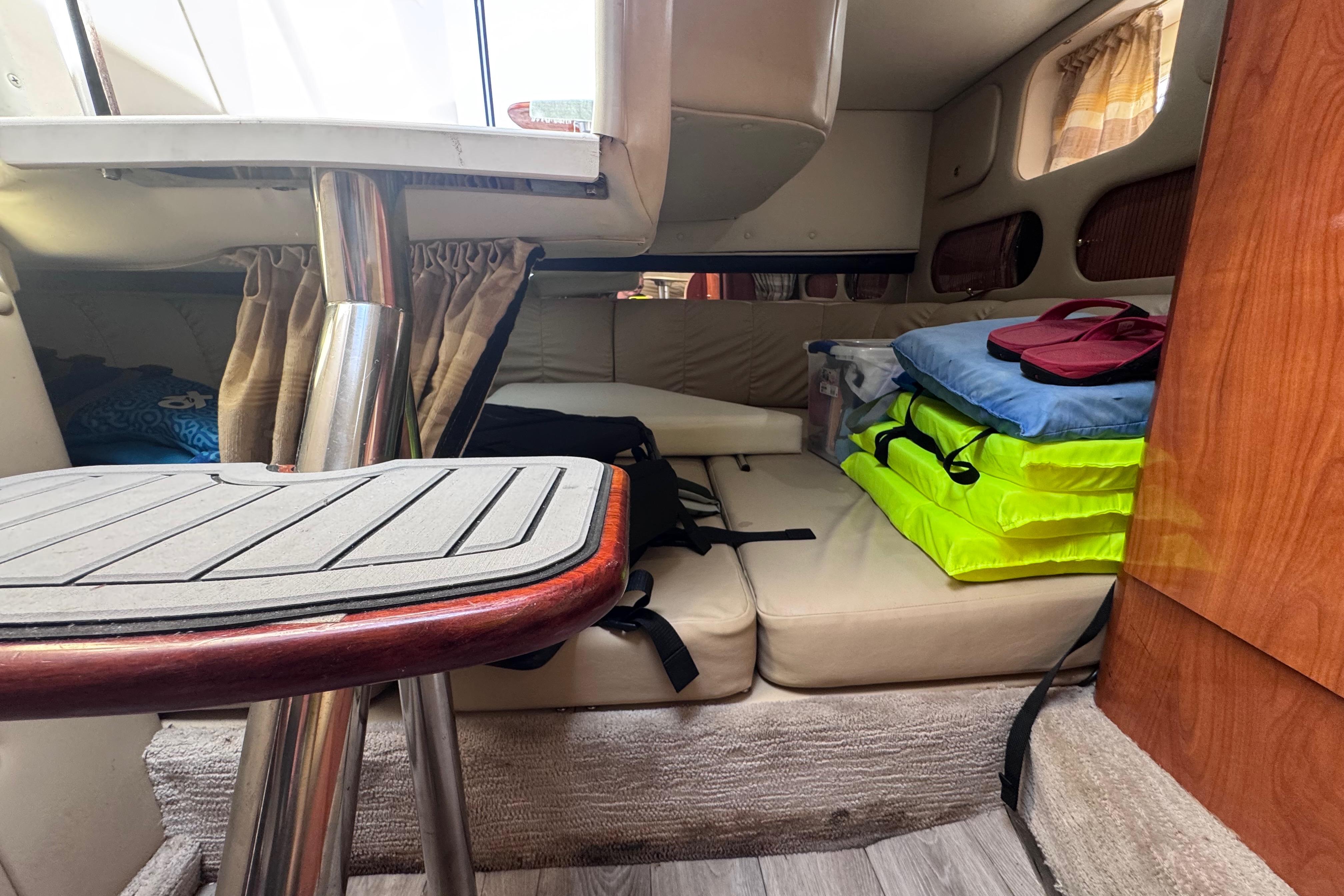 Interior cabin of 2003 Rinker Fiesta Vee 312 boat with seating and storage.