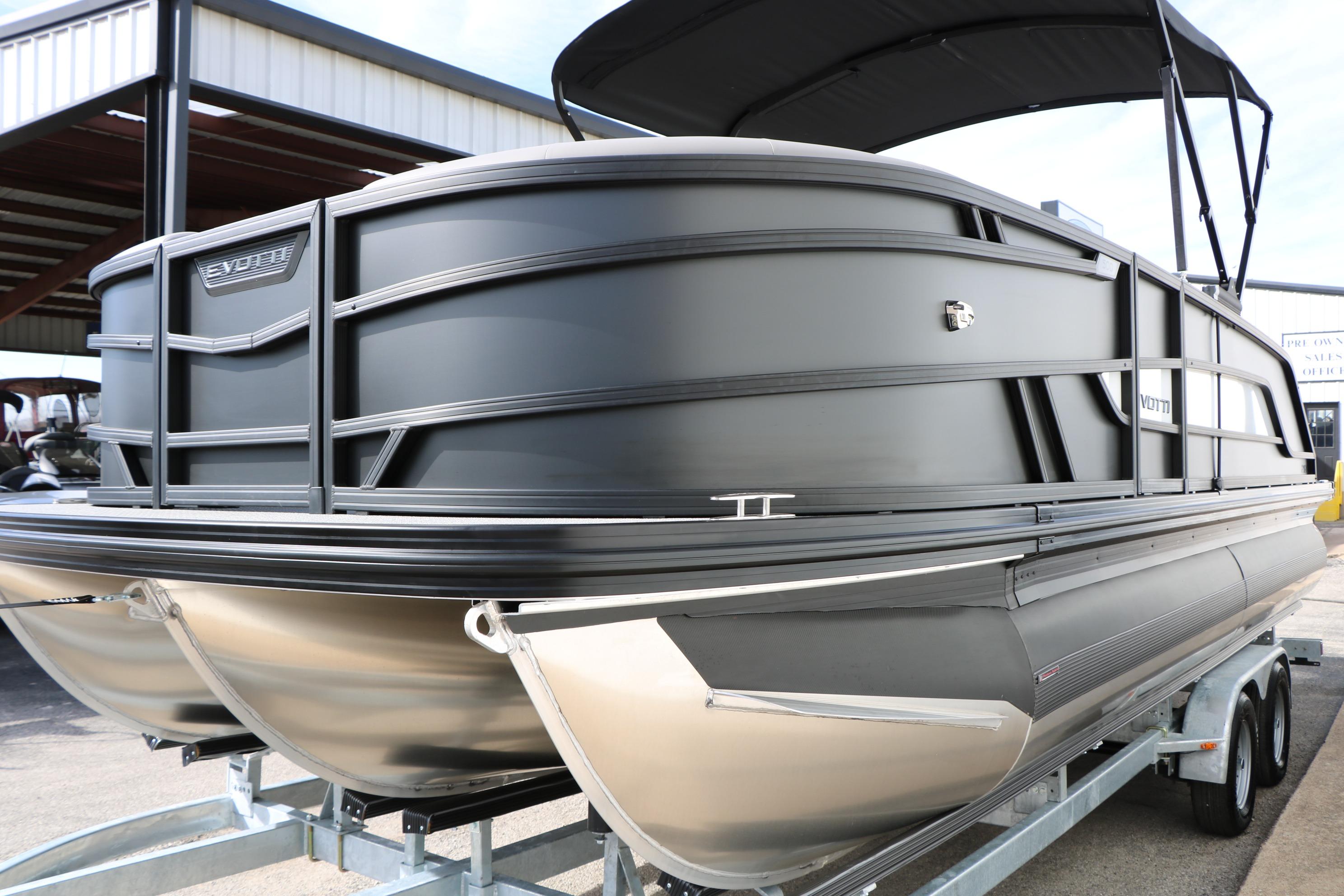 2026 Evotti 521QL pontoon boat on trailer, sleek black design, under a canopy.