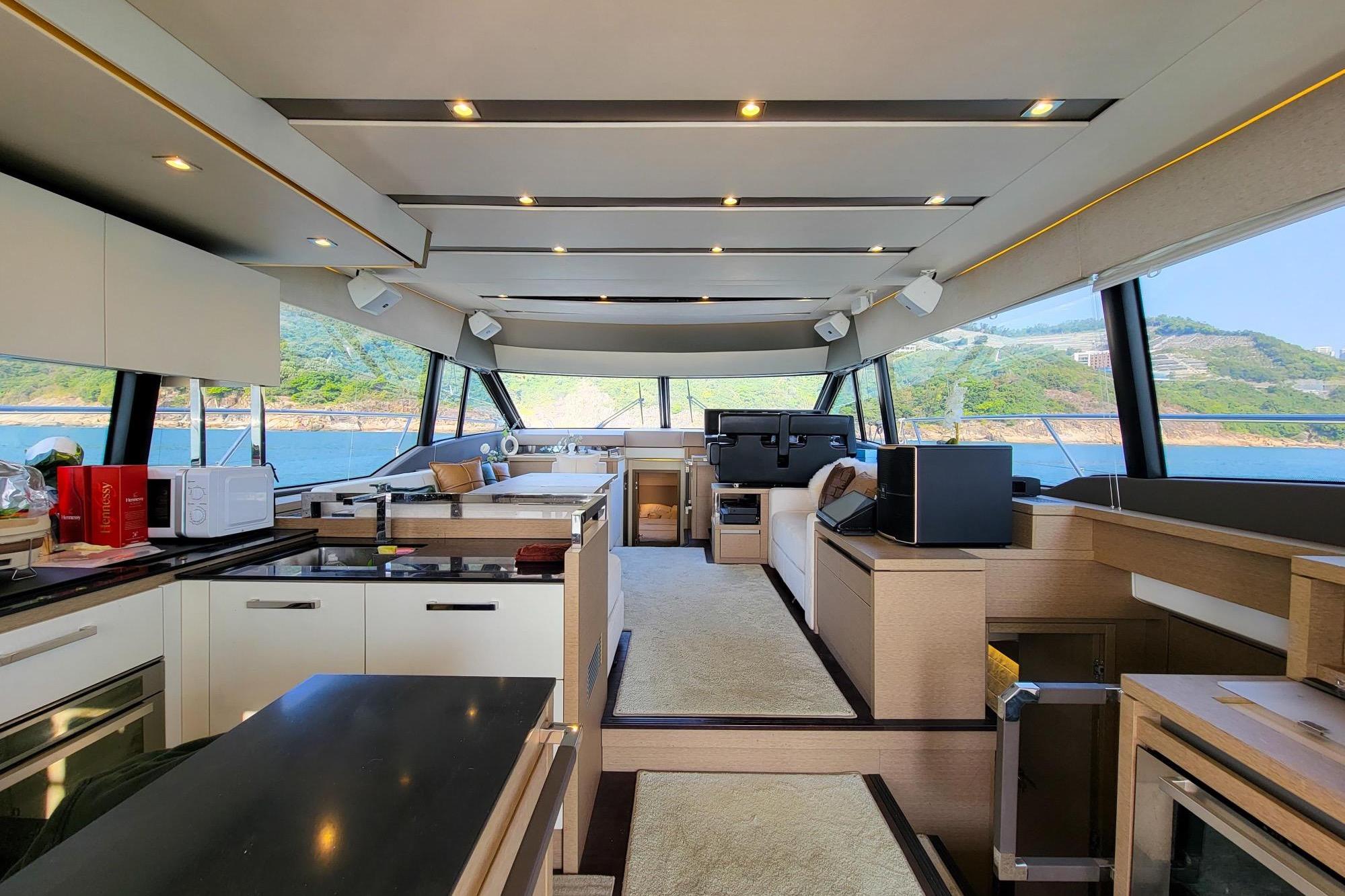 Luxurious interior of a 2019 Prestige 630 yacht with modern kitchen and scenic views.