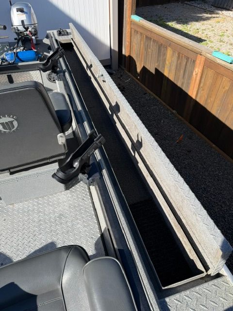 Interior view of a 2008 Willie Boats Predator with storage compartment.