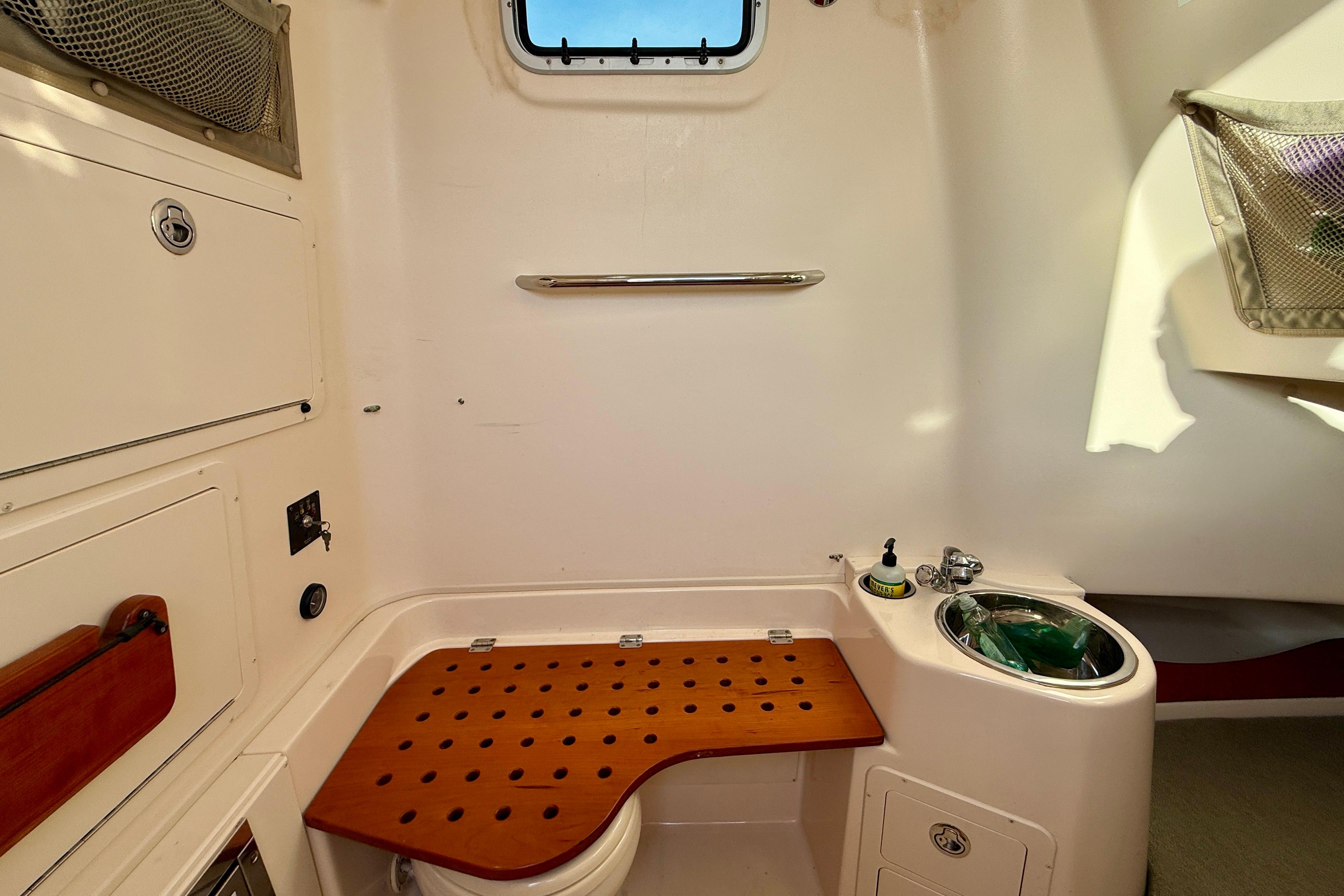 2012 Grady-White Canyon 336 boat interior with sink and storage compartments.