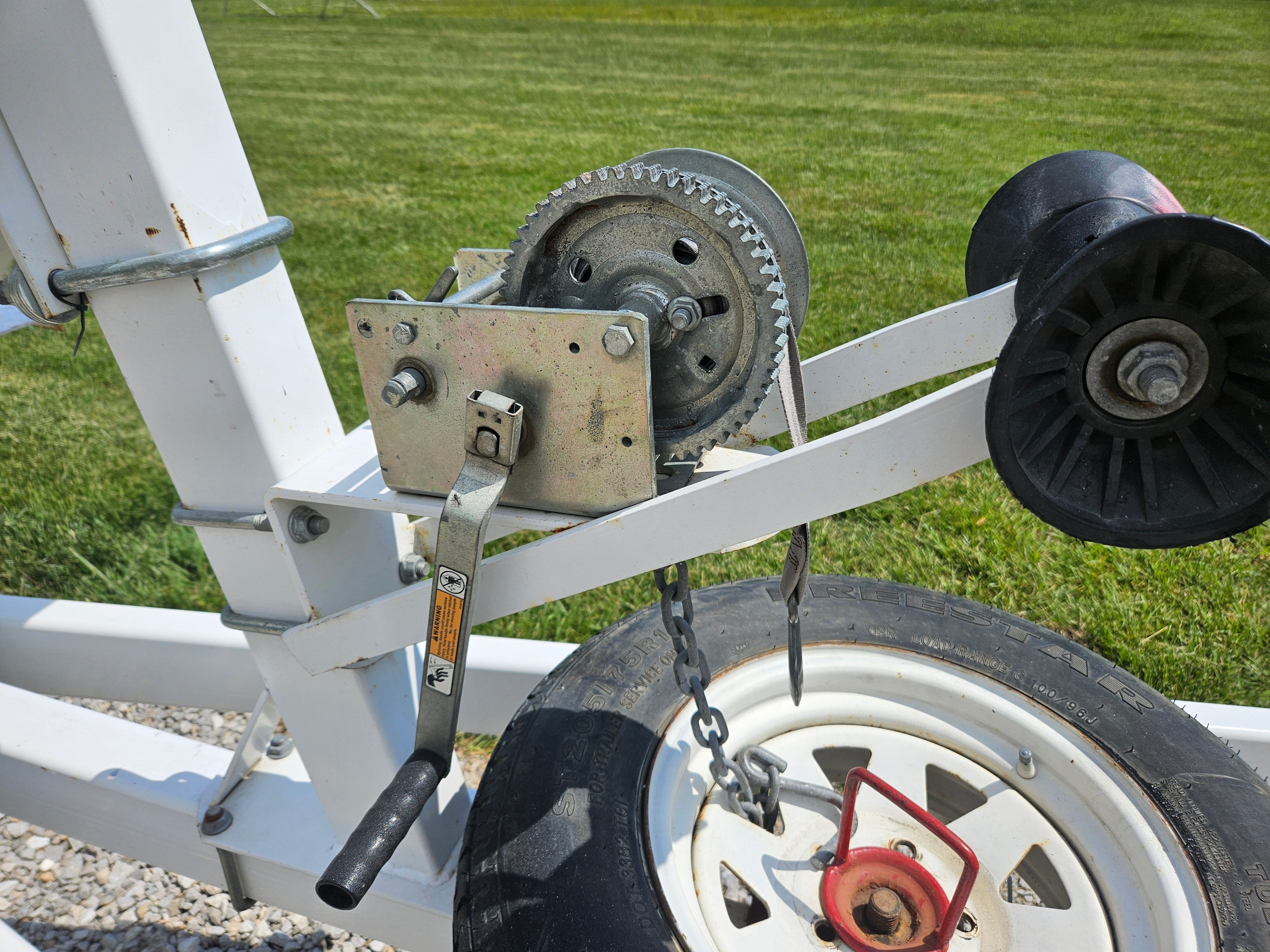Boat trailer winch on Yacht Club R2466TB, 2010 model, on green grass.