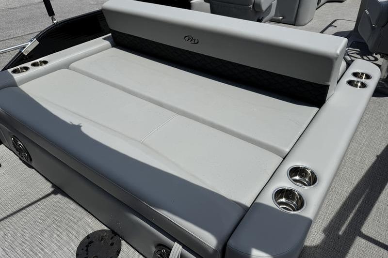 2026 Manitou Encore 25 SL SHP boat seating area with cup holders and sleek design.
