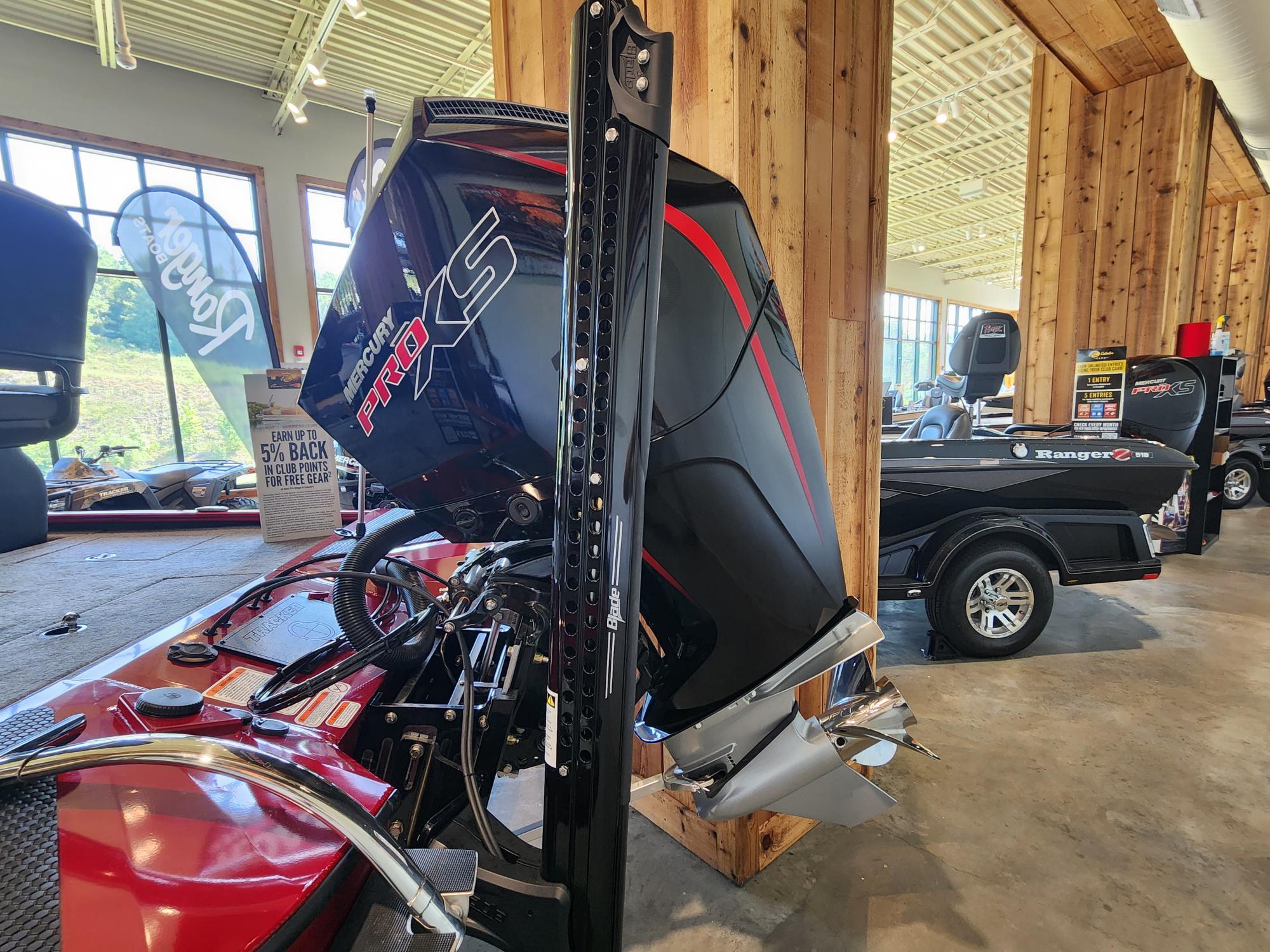 2025 Tracker Savage 215 boat with Mercury Pro XS engine in showroom.