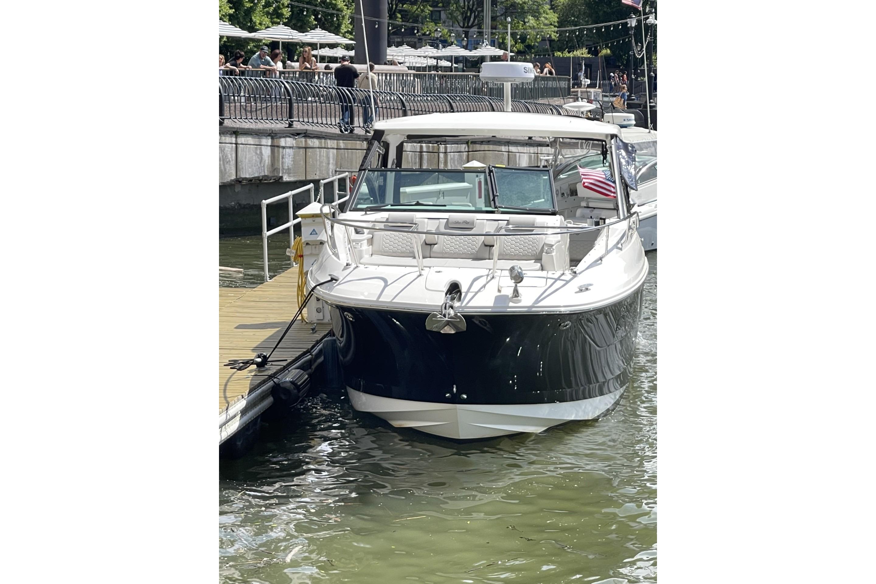 2023 Sea Ray Sundancer 320 docked at a marina, front view.