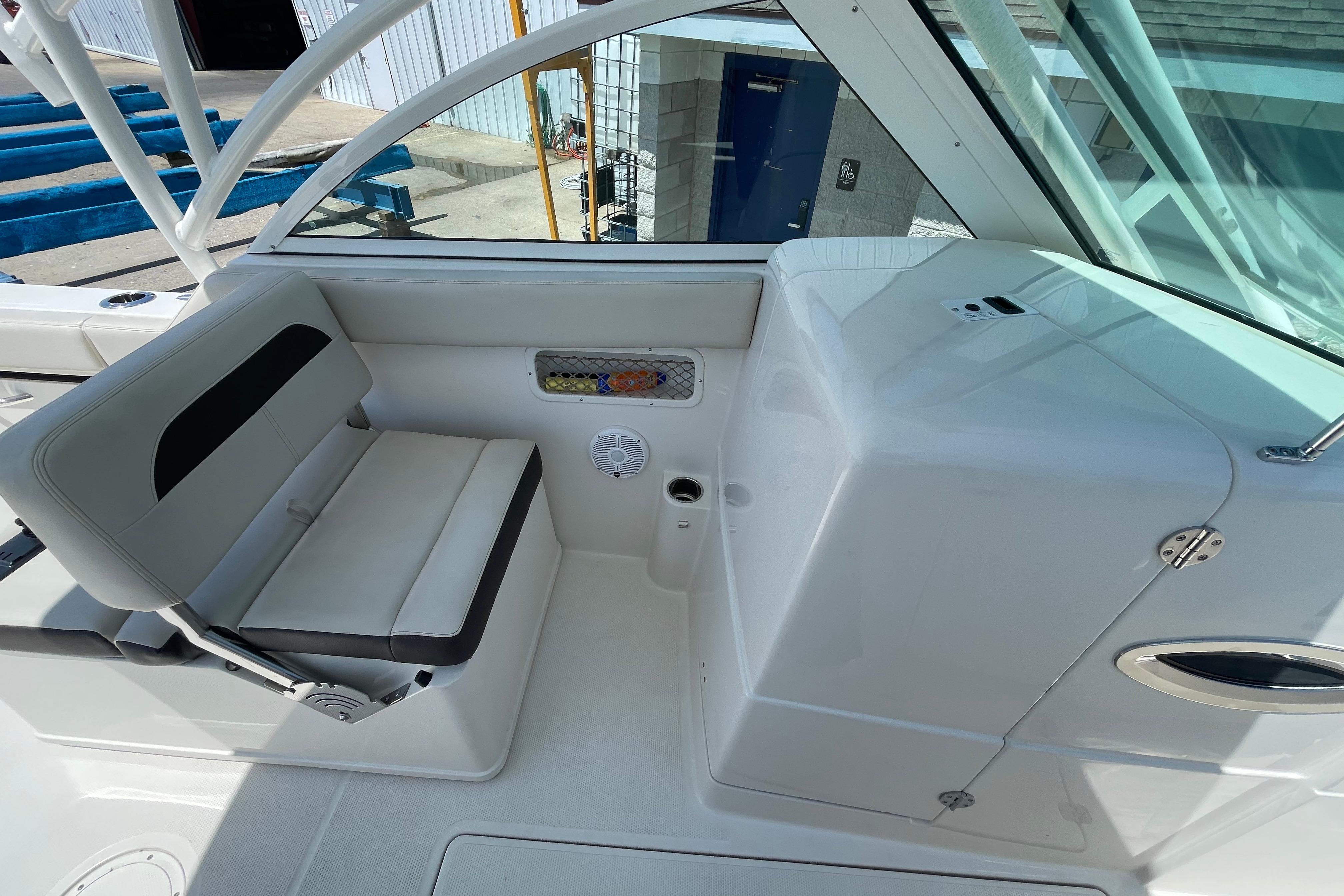 2022 Sailfish 245 DC boat interior with seating and storage compartments.