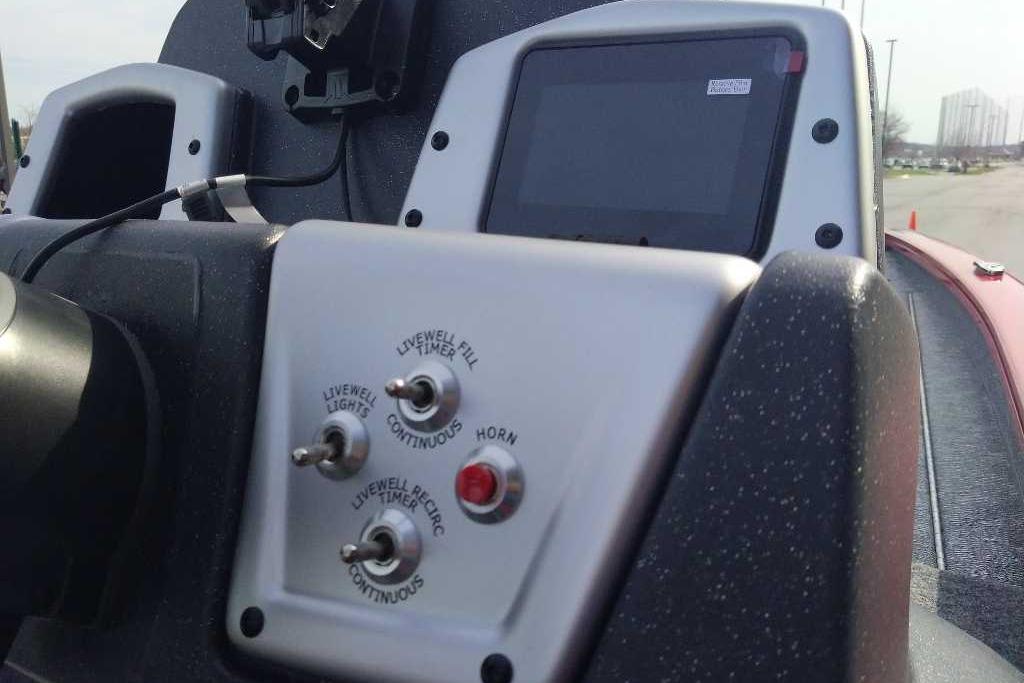 Control panel of 2026 Tracker Pro Team 195 boat with switches and display screen.