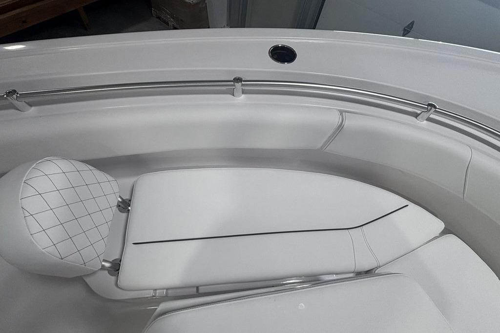 2026 Sportsman Open 252 Center Console boat interior with cushioned seating and stainless steel railing.