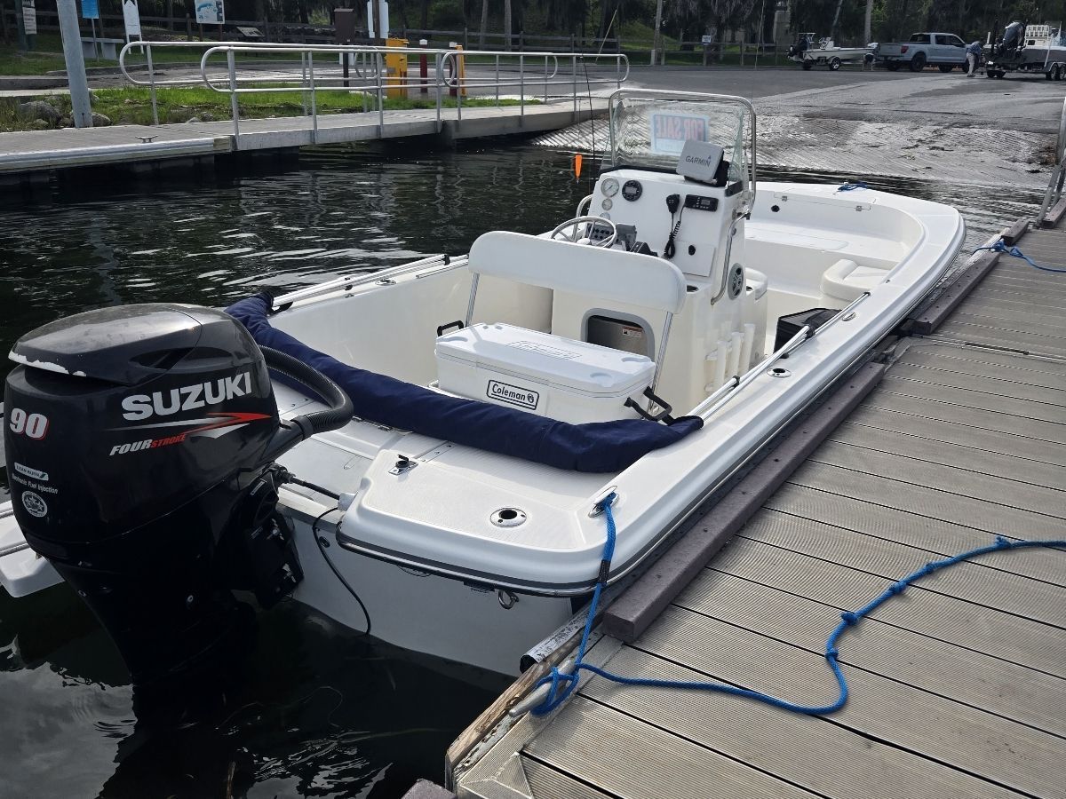 2014 Sundance DX20 boat docked with Suzuki engine.