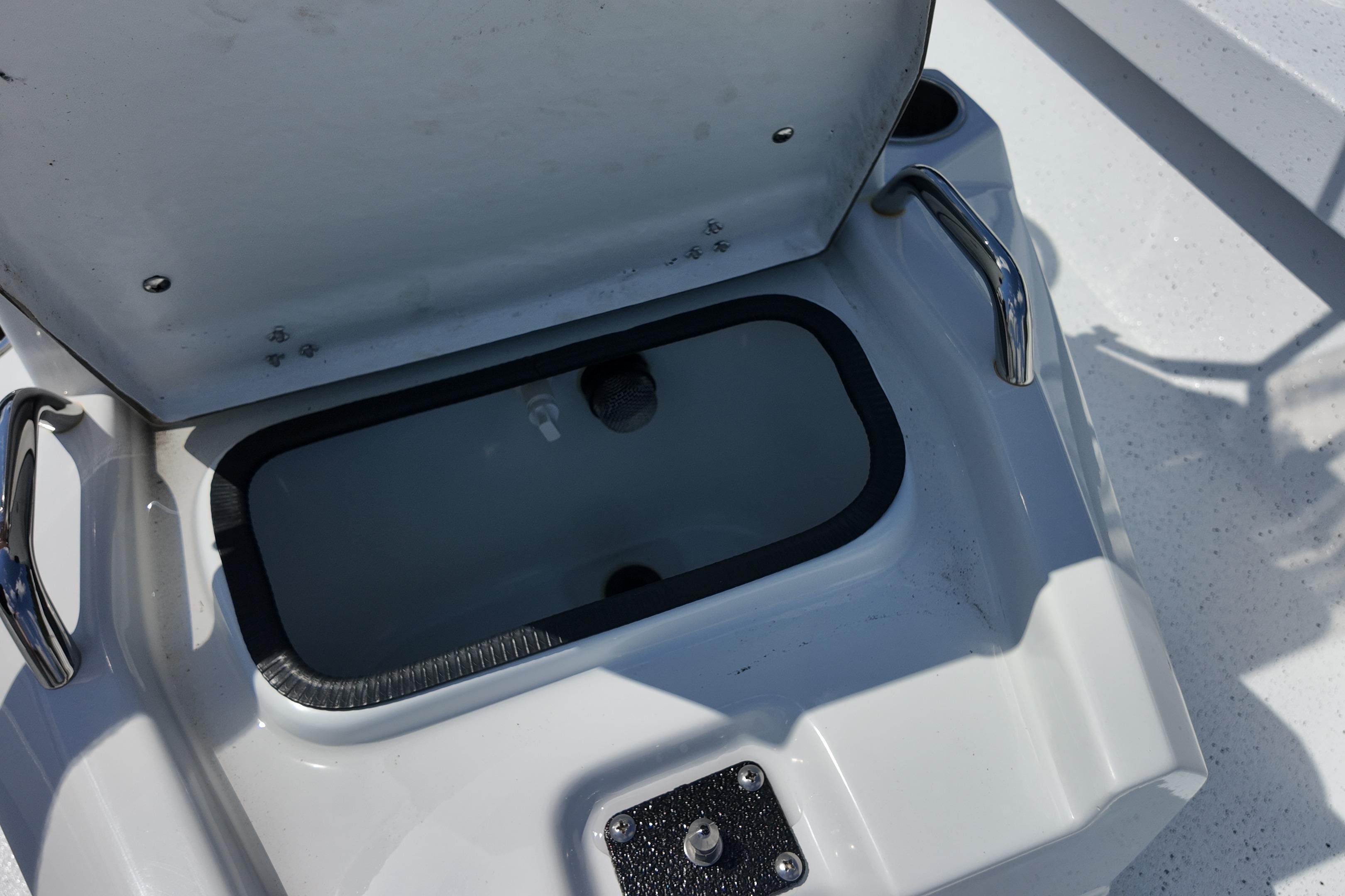 Open storage compartment on 2026 Xpress H20 boat, featuring stainless steel handles.
