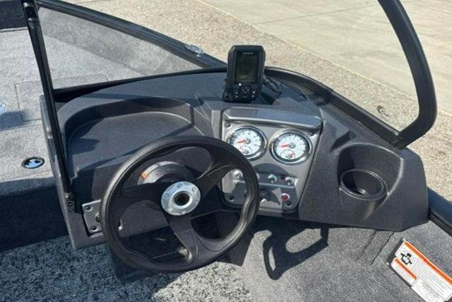 2026 Tracker Pro Guide V-16 WT boat dashboard with steering wheel and gauges.
