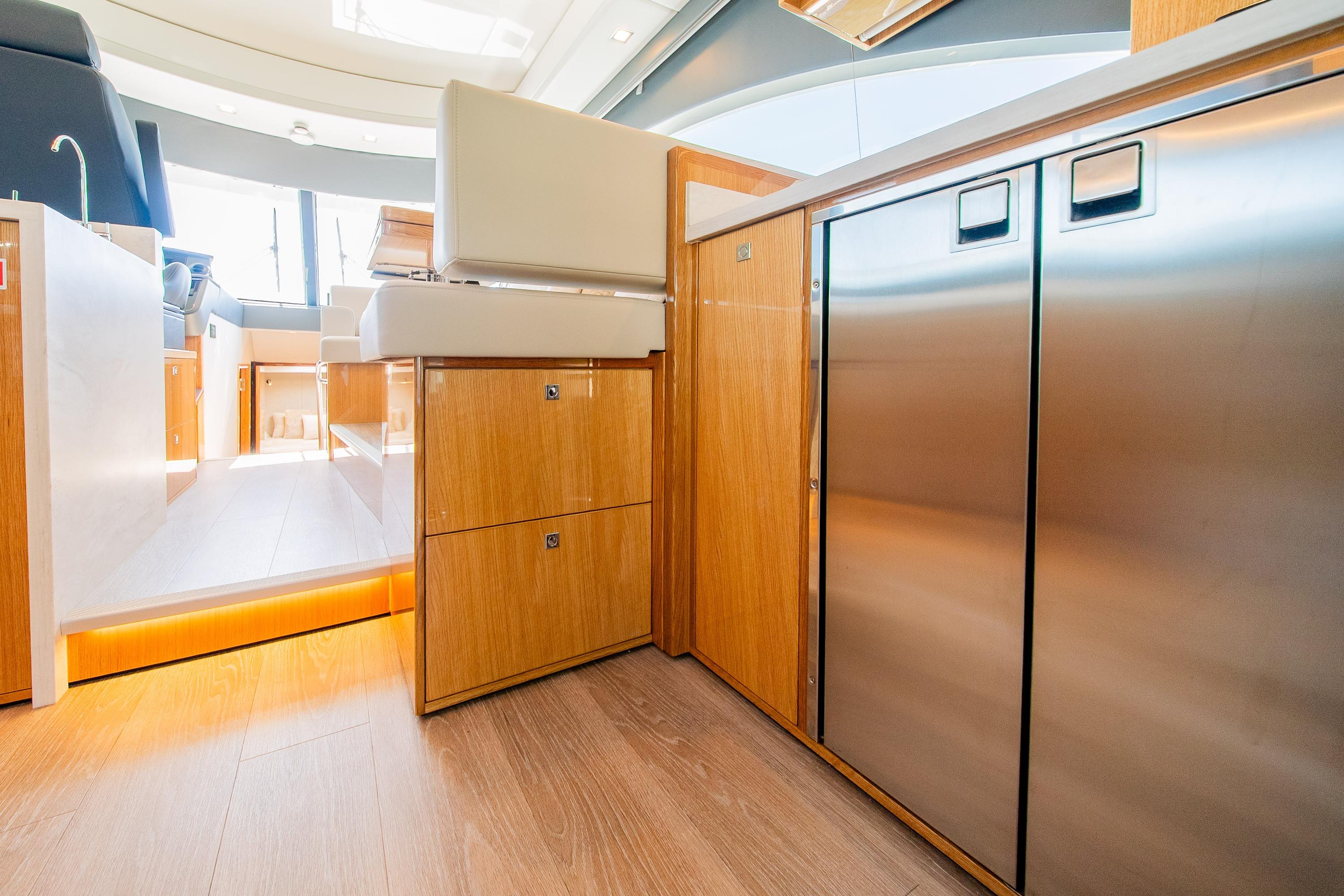 Luxurious interior of 2026 Riviera 4600 Sport Yacht Platinum Edition with sleek cabinetry.