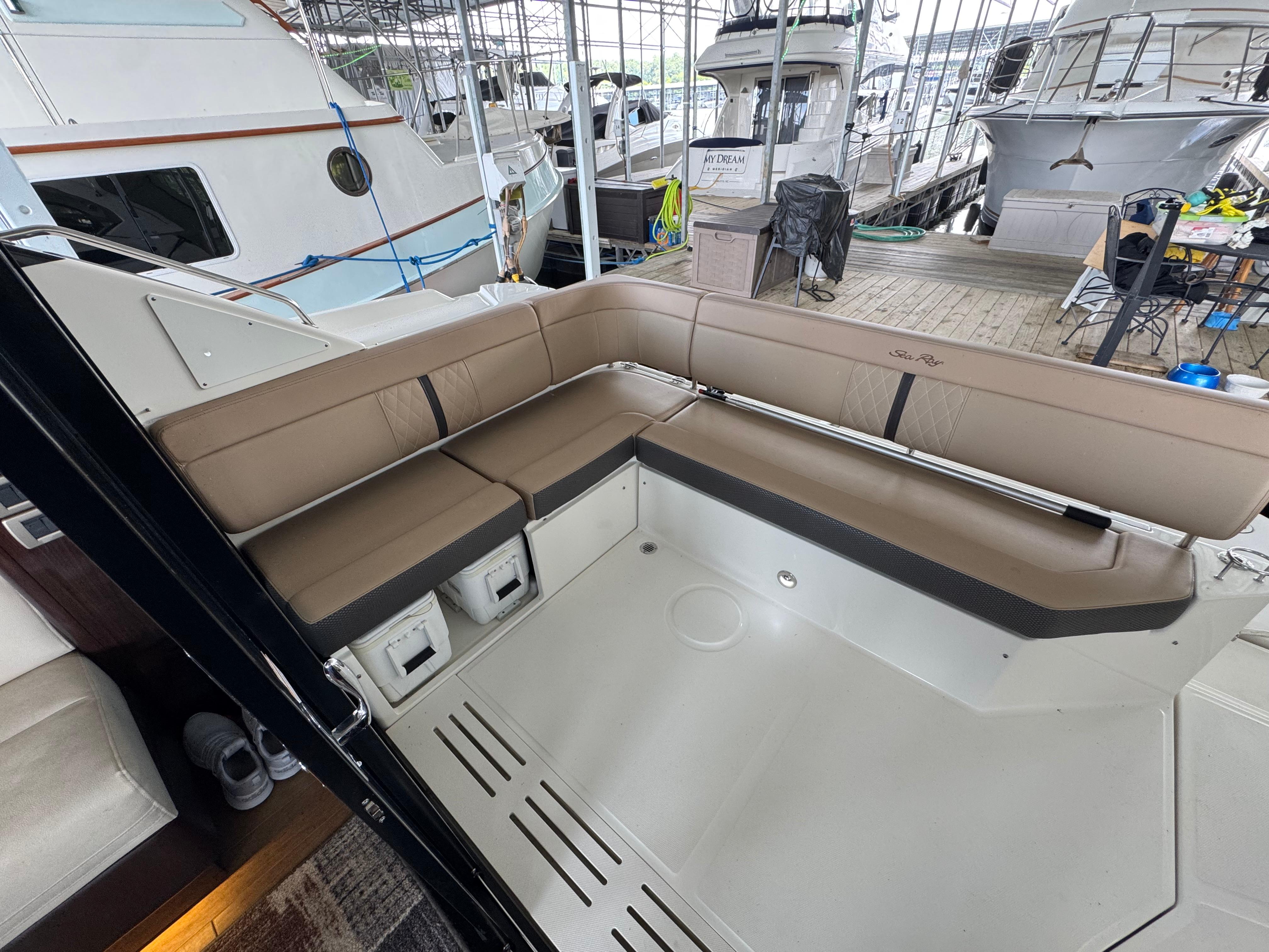 2017 Sea Ray Sundancer 400 yacht with spacious outdoor seating area in marina.