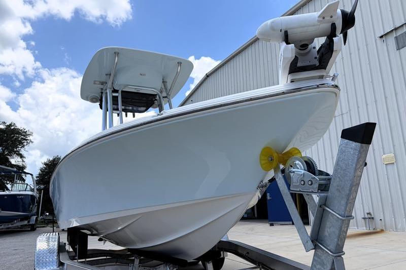 2025 Key West 210 Bay Reef boat on trailer, parked near a building under a blue sky.