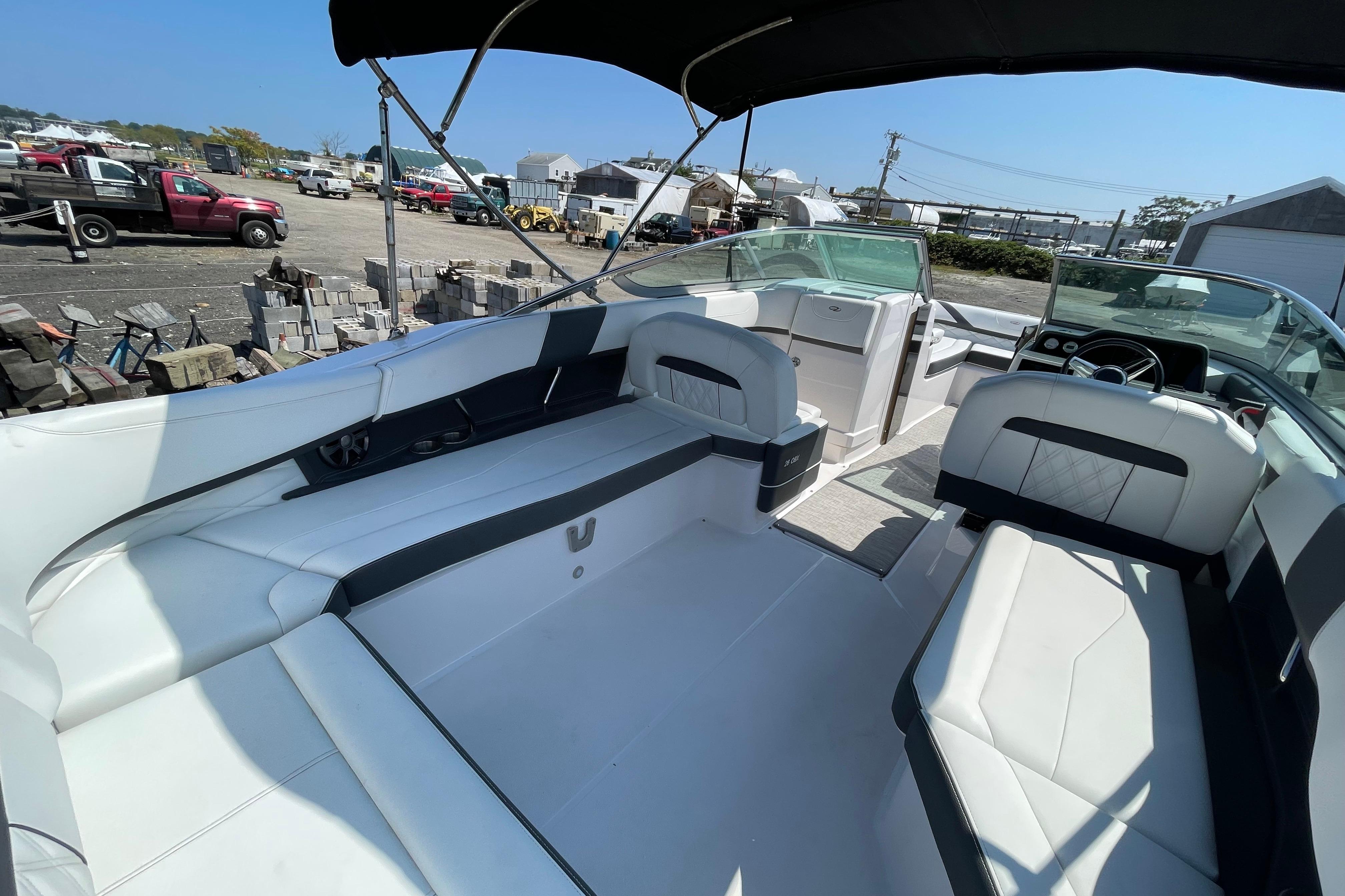 2018 Regal 26 OBX boat interior with white seating and black accents under a canopy.