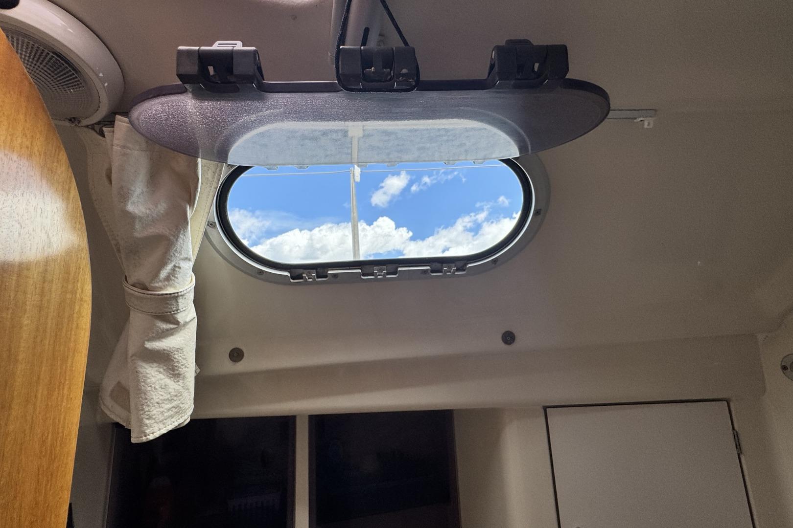 Cabin view through a porthole on a 2002 Dufour Gib'Sea 43 sailboat.