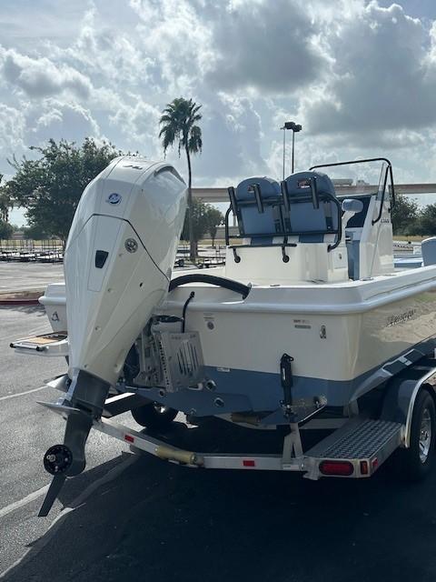 2025 Ranger 2360 Bay boat on trailer, parked outdoors under cloudy sky.