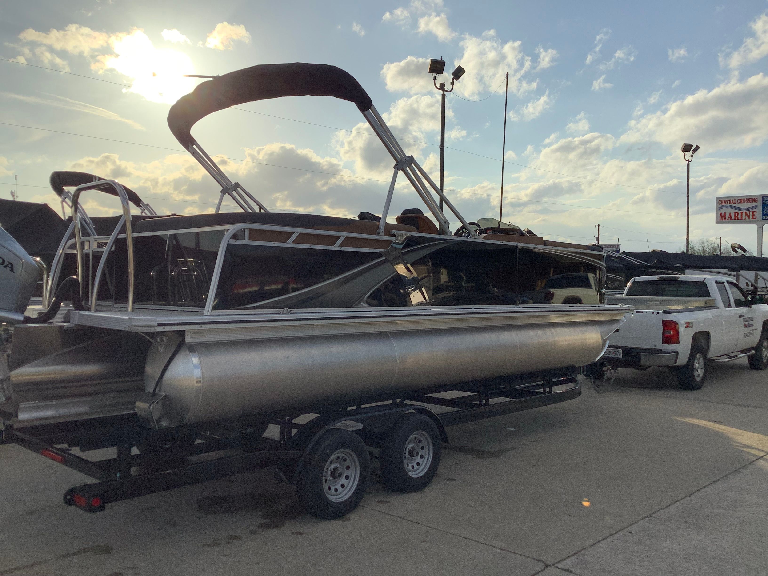 2026 Tahoe 2385 LTZ pontoon boat on trailer at sunset.