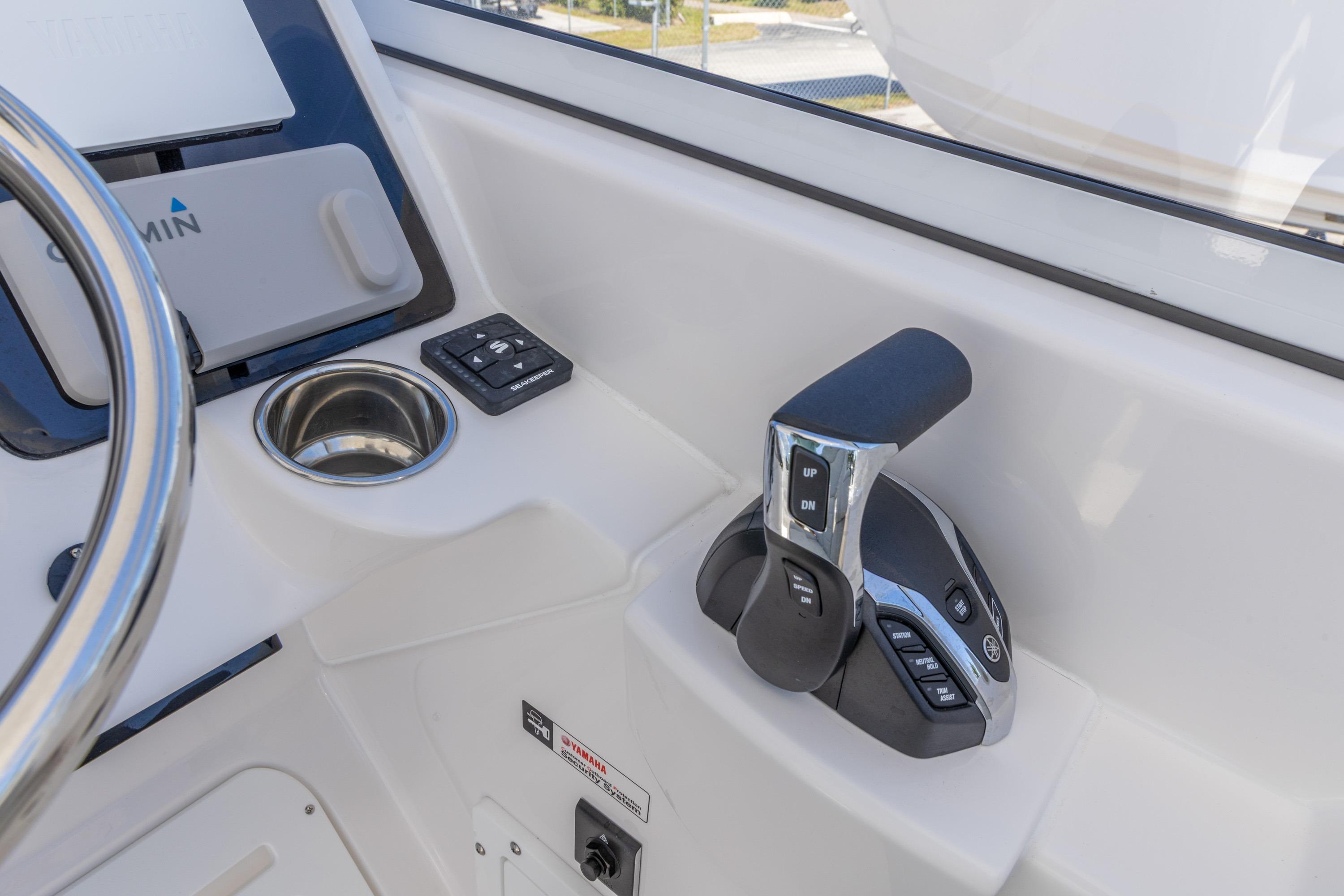 2026 Edgewater 248CX Crossover boat cockpit with throttle controls and Garmin display.