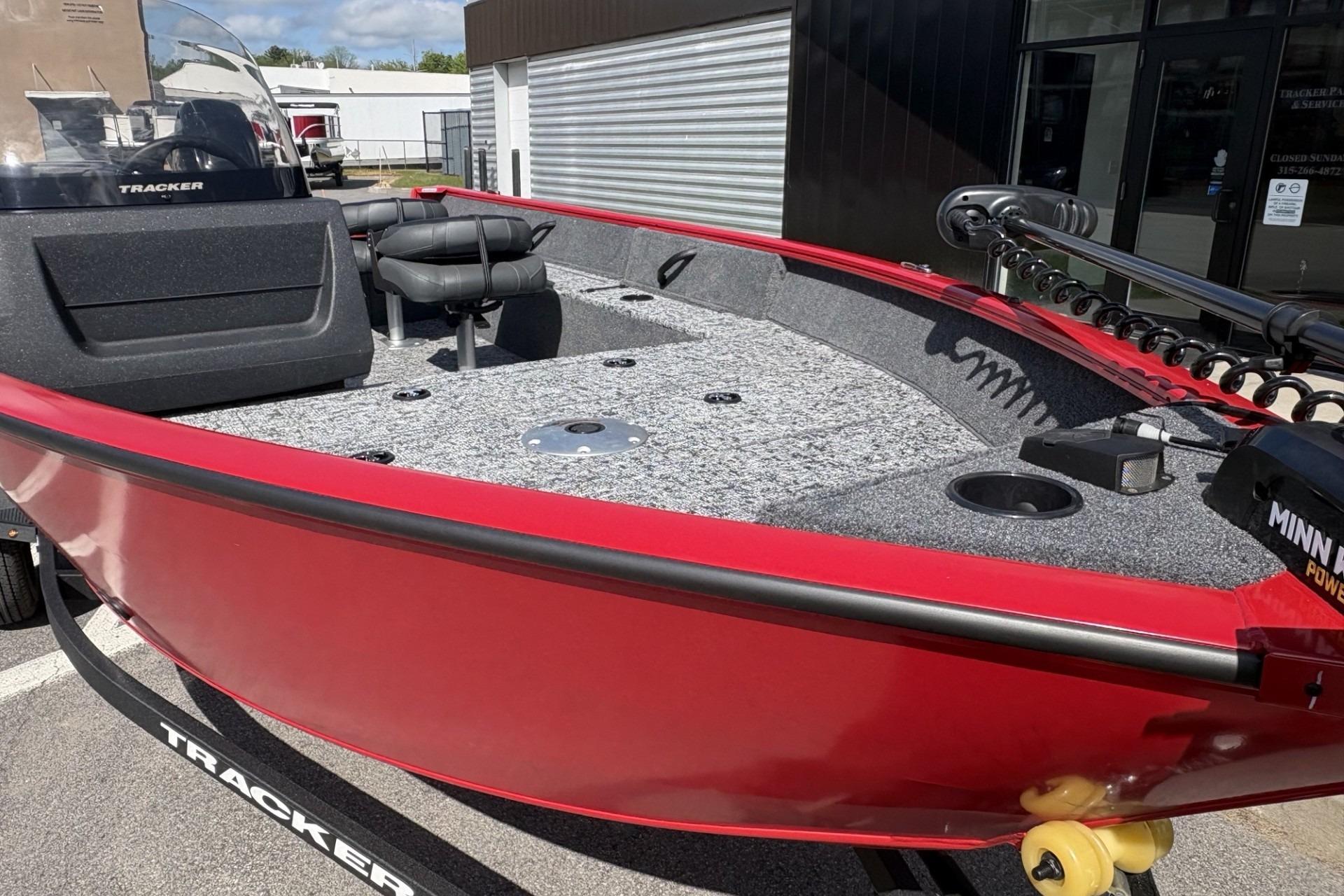2026 Tracker Pro Guide V-16 SC boat, red exterior, gray interior, on a trailer.