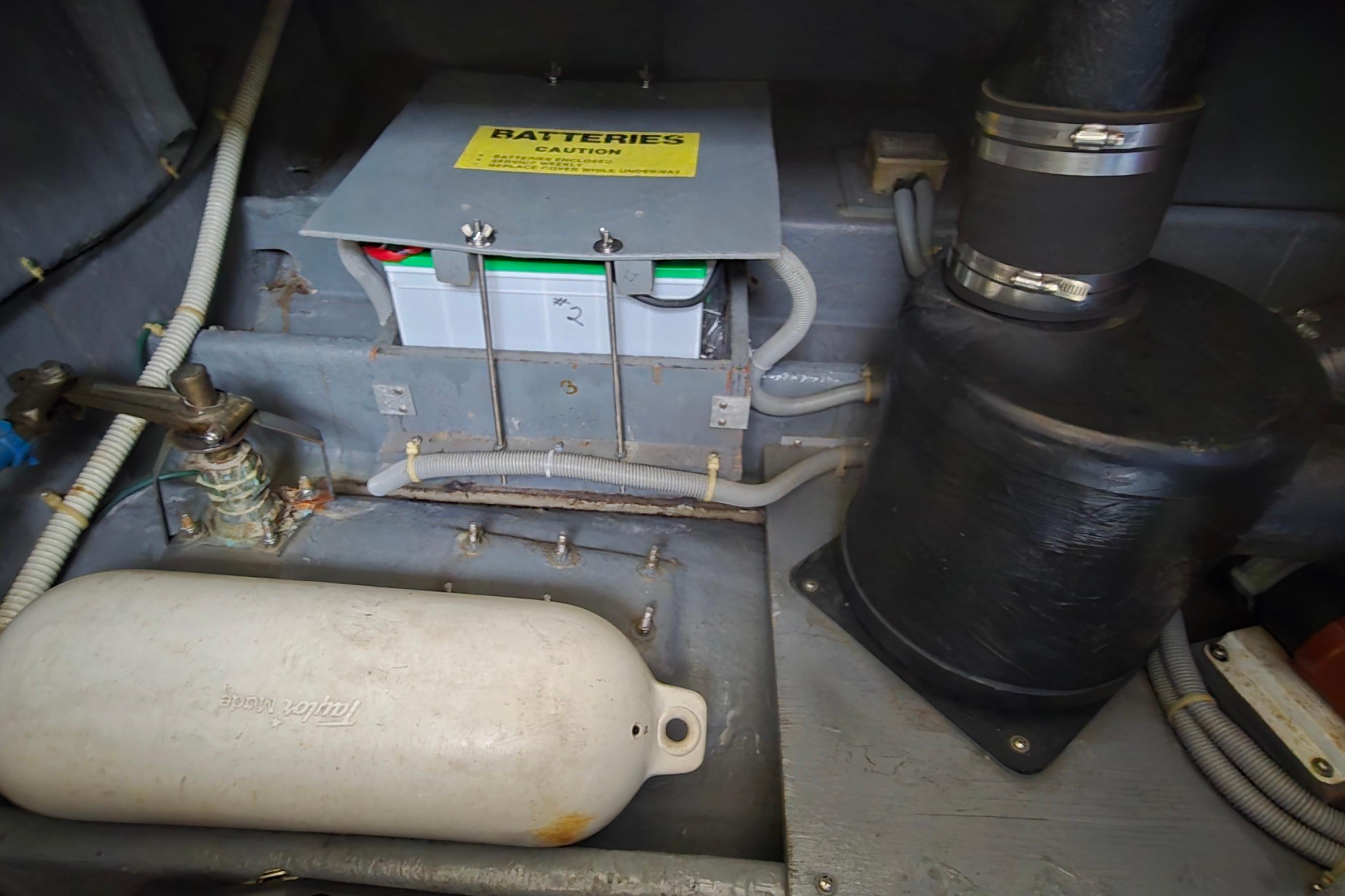 Engine compartment of 1987 Sea Ray 340 Sedan Bridge showing battery and components.