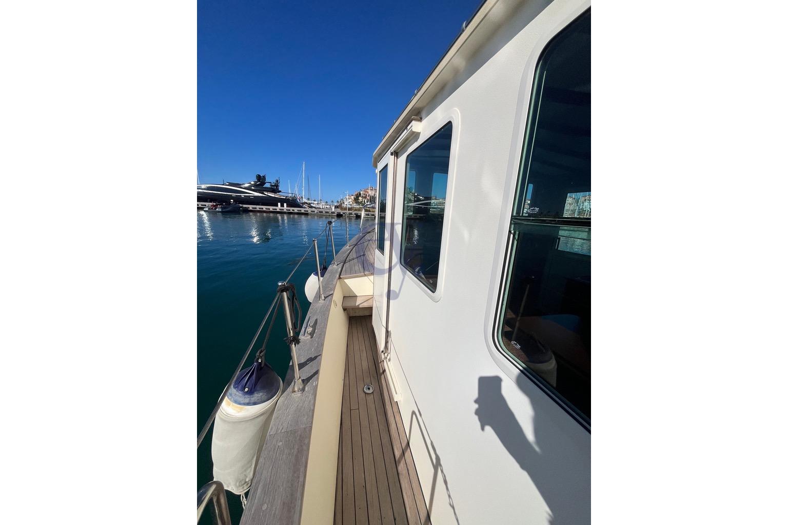 Side view of 2012 Sibma Navale Italiana Armstrong 12 yacht docked in marina.