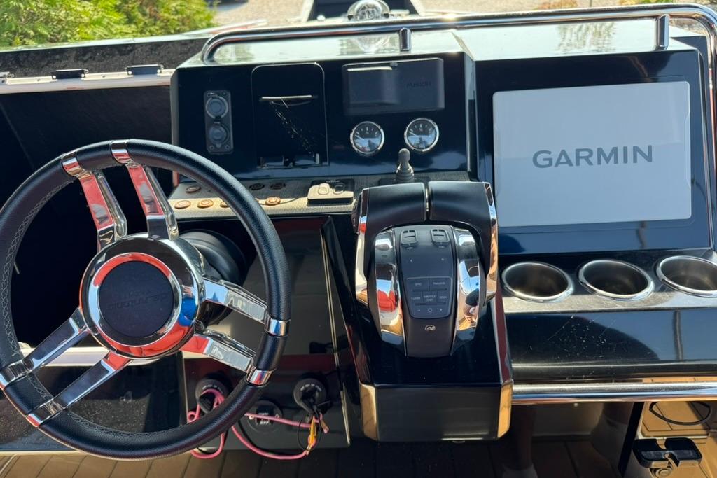 Helm of 2020 De Antonio Yachts D28 featuring Garmin navigation system and modern controls.