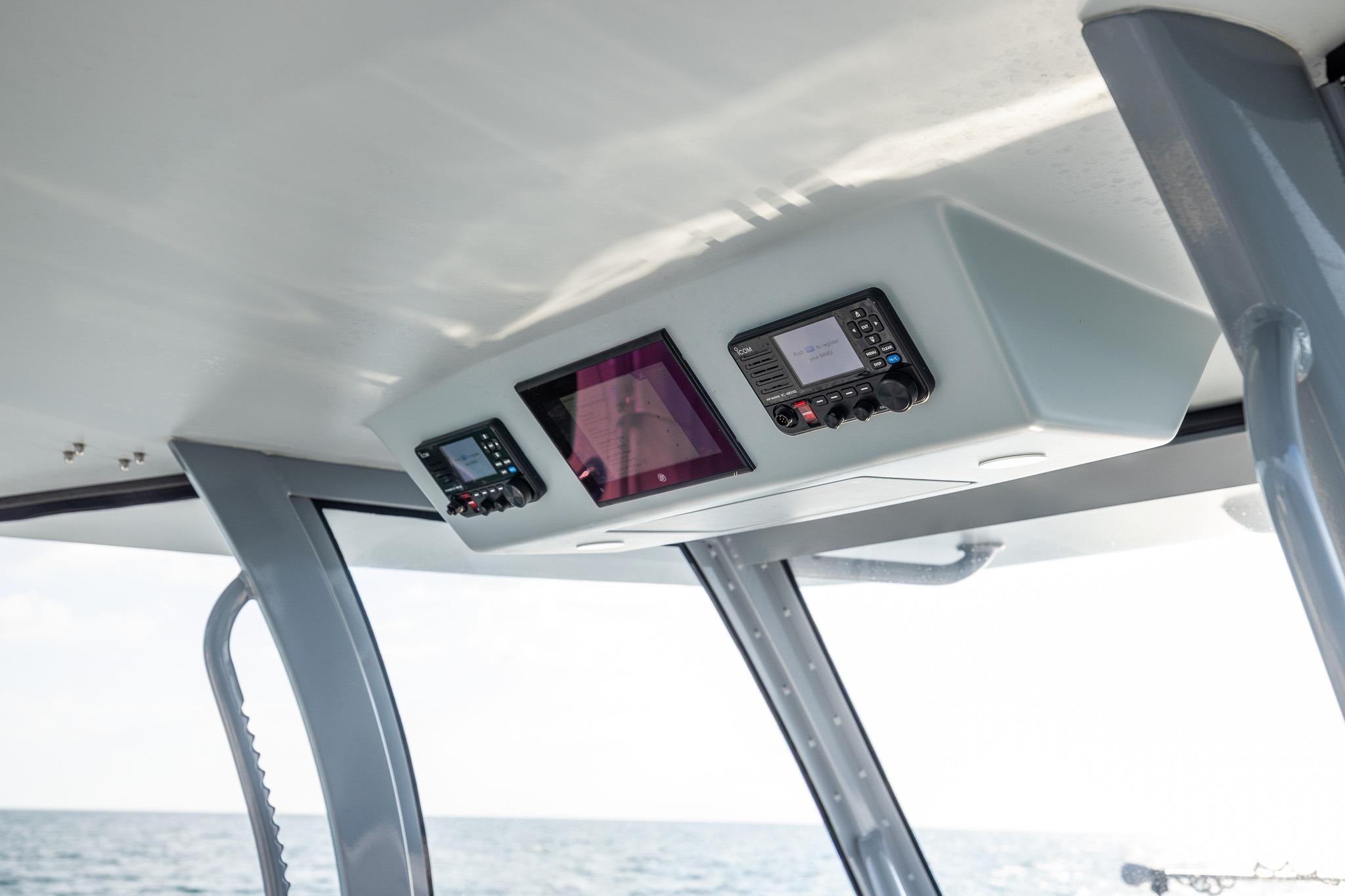 Interior view of 2026 Front Runner 37 Catamaran's control panel with ocean backdrop.