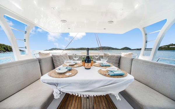 Luxurious Sunreef 60 LOFT yacht dining area with elegant table setting, ocean view, 2016 model.
