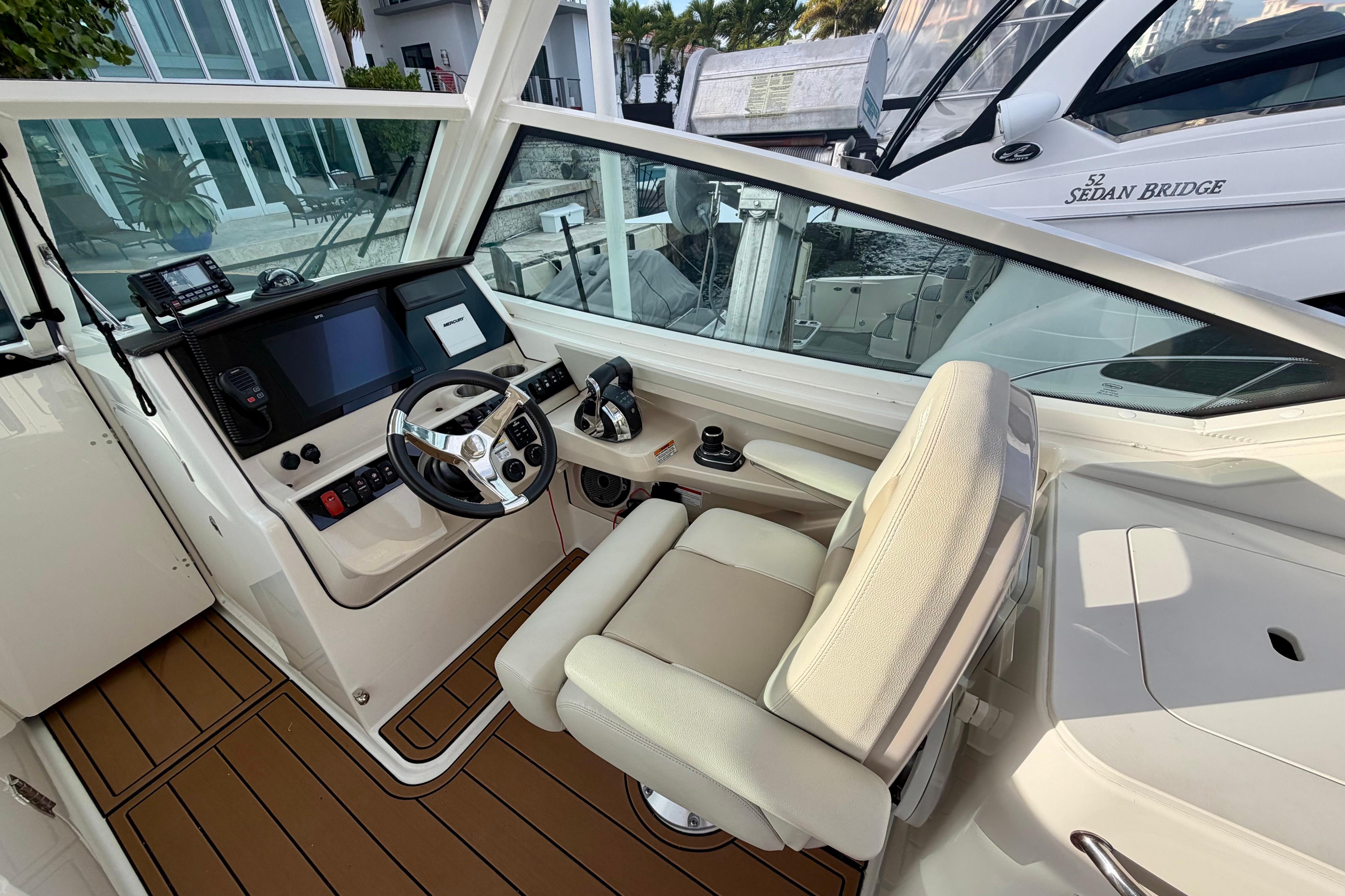 Helm of 2022 Boston Whaler 280 Vantage with modern controls and comfortable seating.