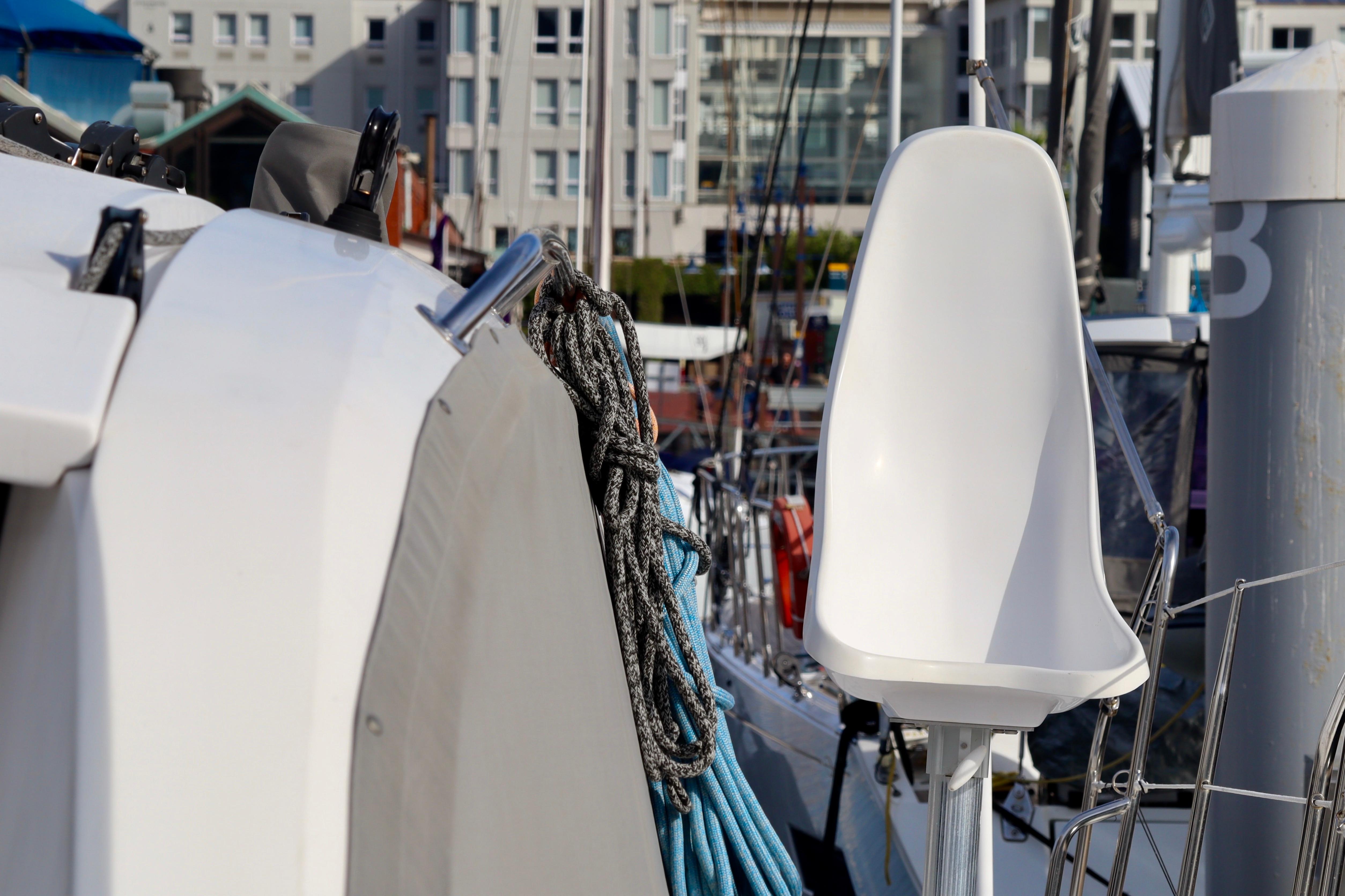2017 Outremer 51 yacht with ropes and seating, docked in a marina.