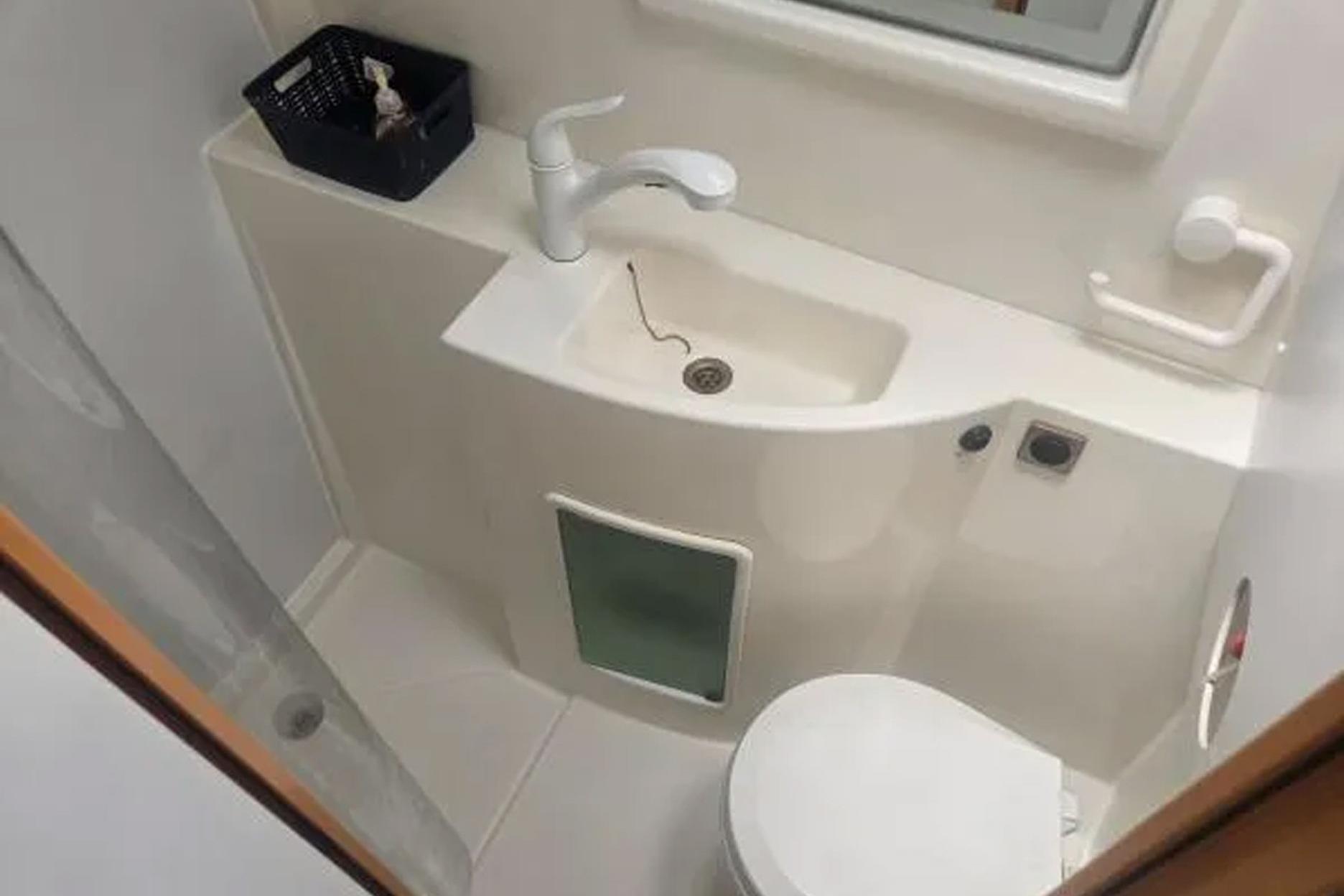 Compact bathroom in 2008 Fountaine Pajot Salina 48 catamaran, featuring sink and toilet.