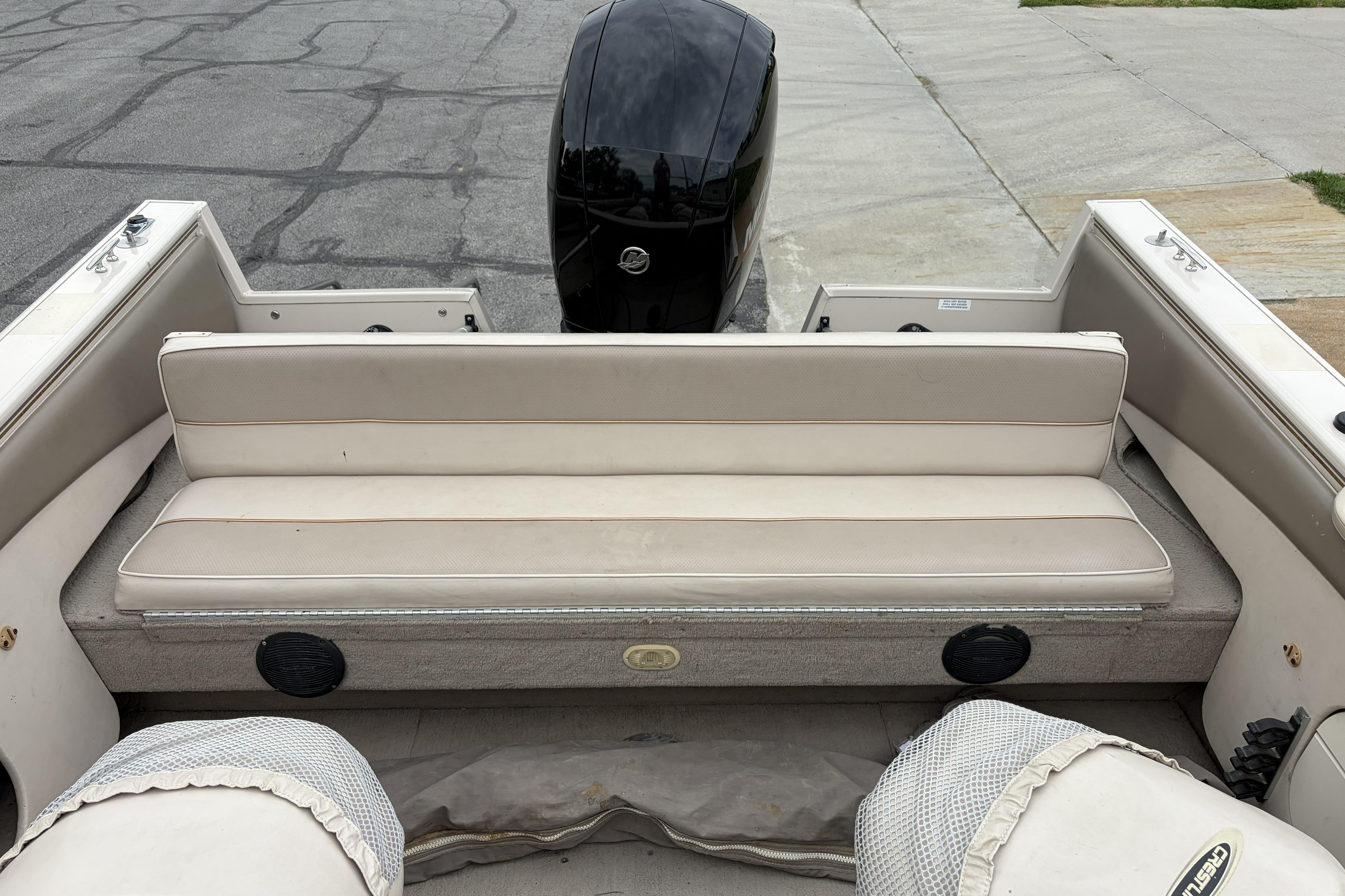2002 Crestliner 1850 Sportfish boat interior with beige seating and outboard motor.