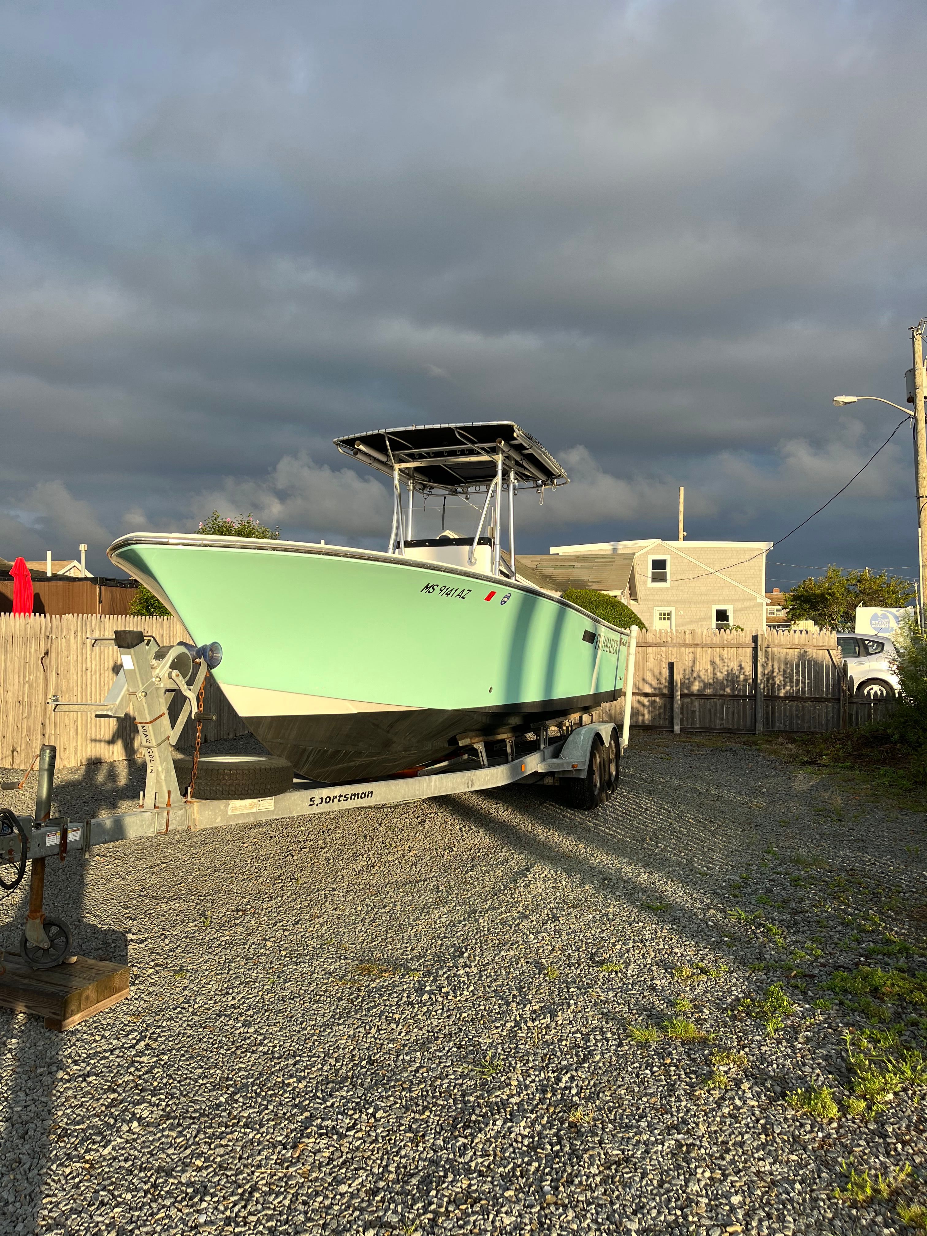 SeaCraft SXCRB730H001 2001 boat on trailer under cloudy sky.