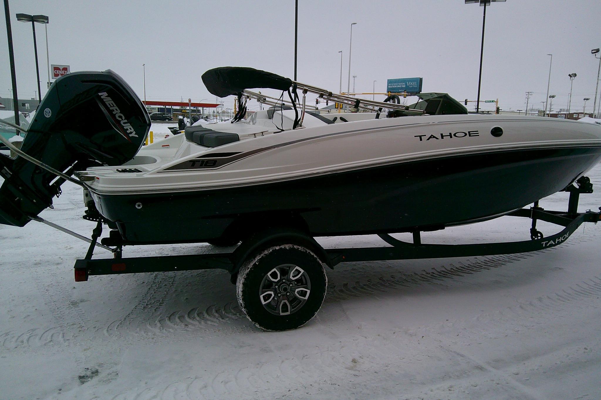 2026 Tahoe T18 boat on trailer in snowy parking lot.