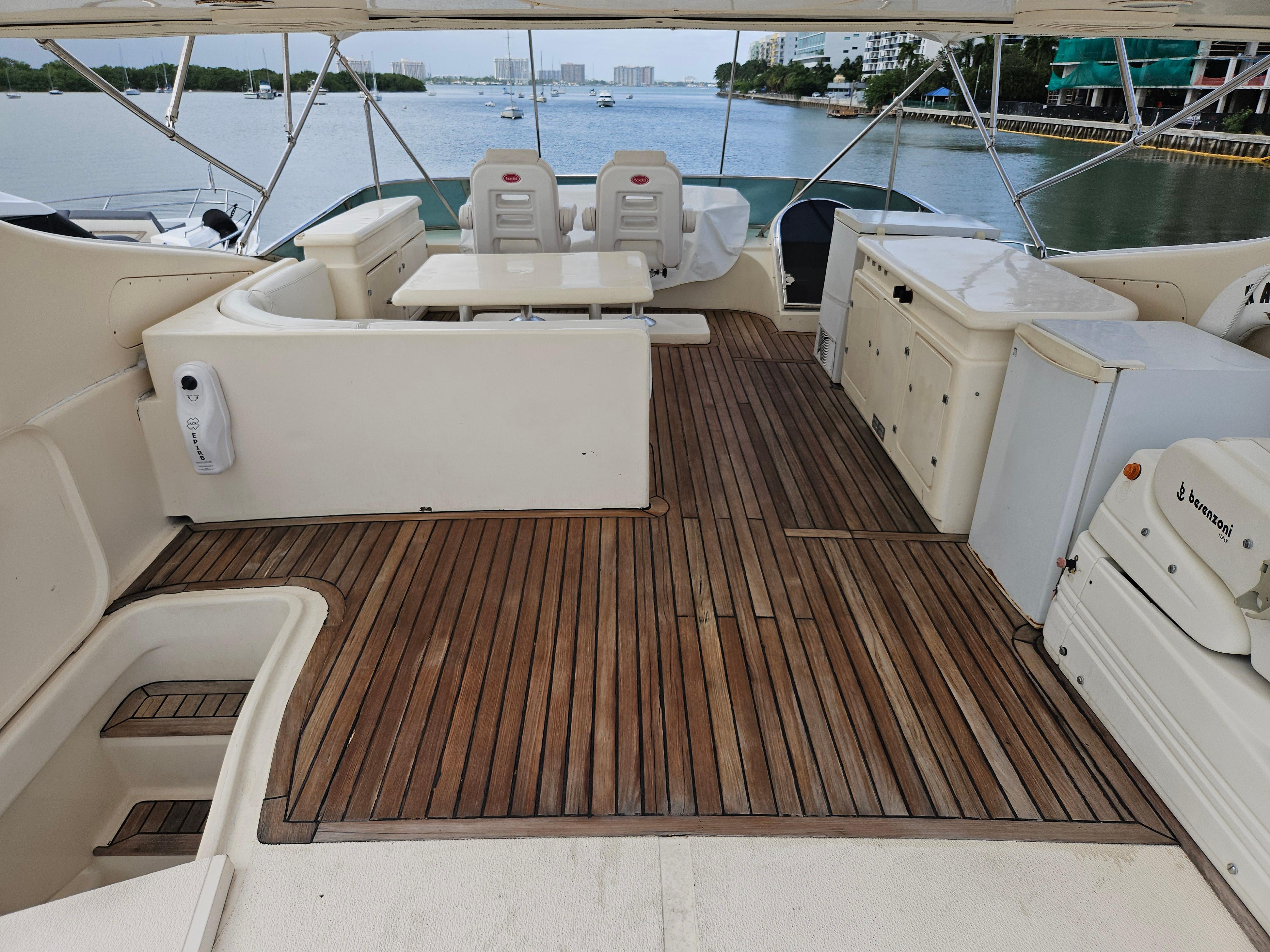 Astondoa 72 GLX yacht deck with seating, table, and scenic water view, 1998 model.