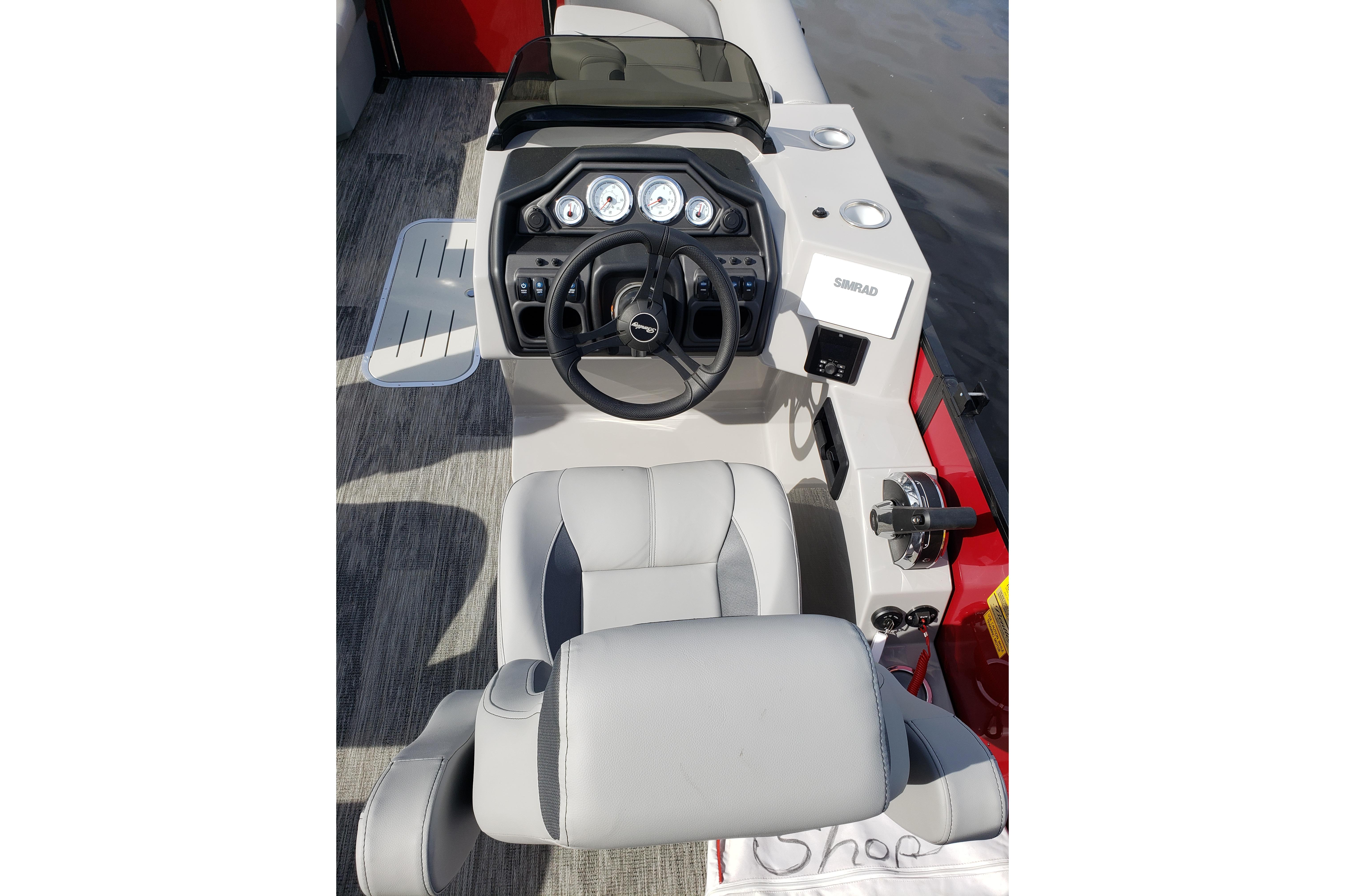2026 Bentley Pontoons Legacy 243 Navigator Ext helm with modern controls and seating.