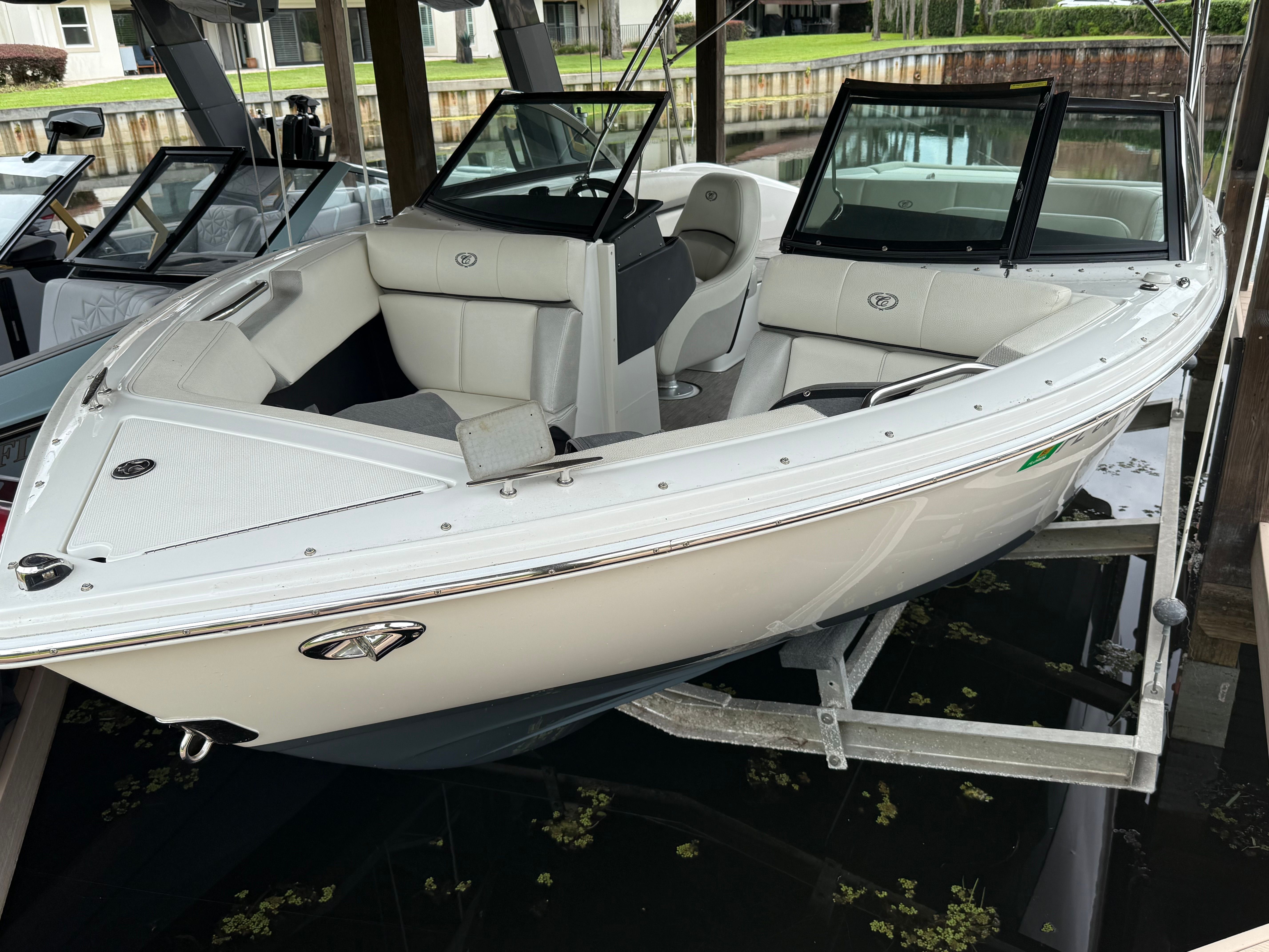A white 2019 Cobalt CS22 Bowrider boat on a boat lift.