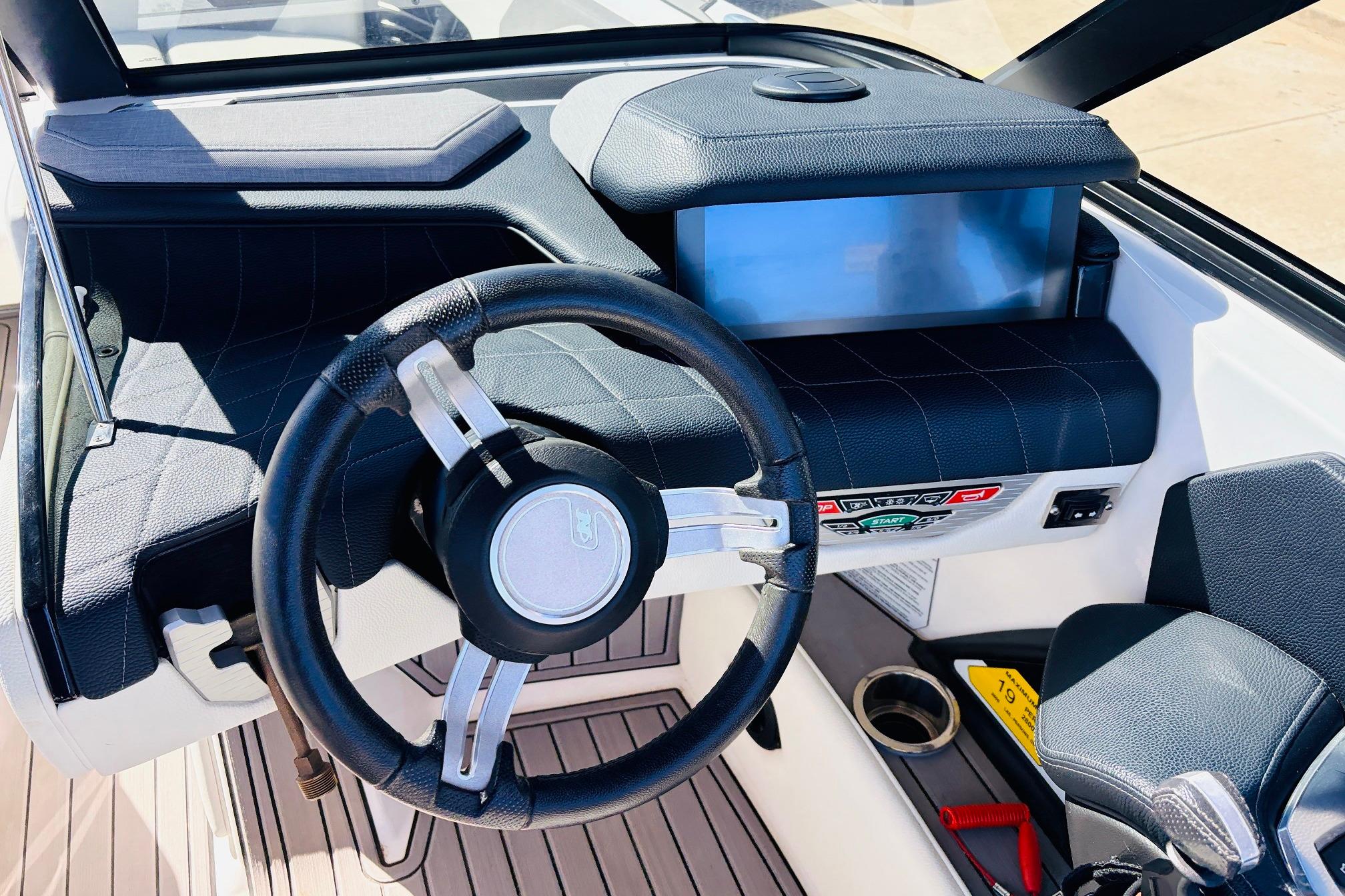 2023 Nautique Super Air Nautique G25 dashboard with steering wheel and control panel.