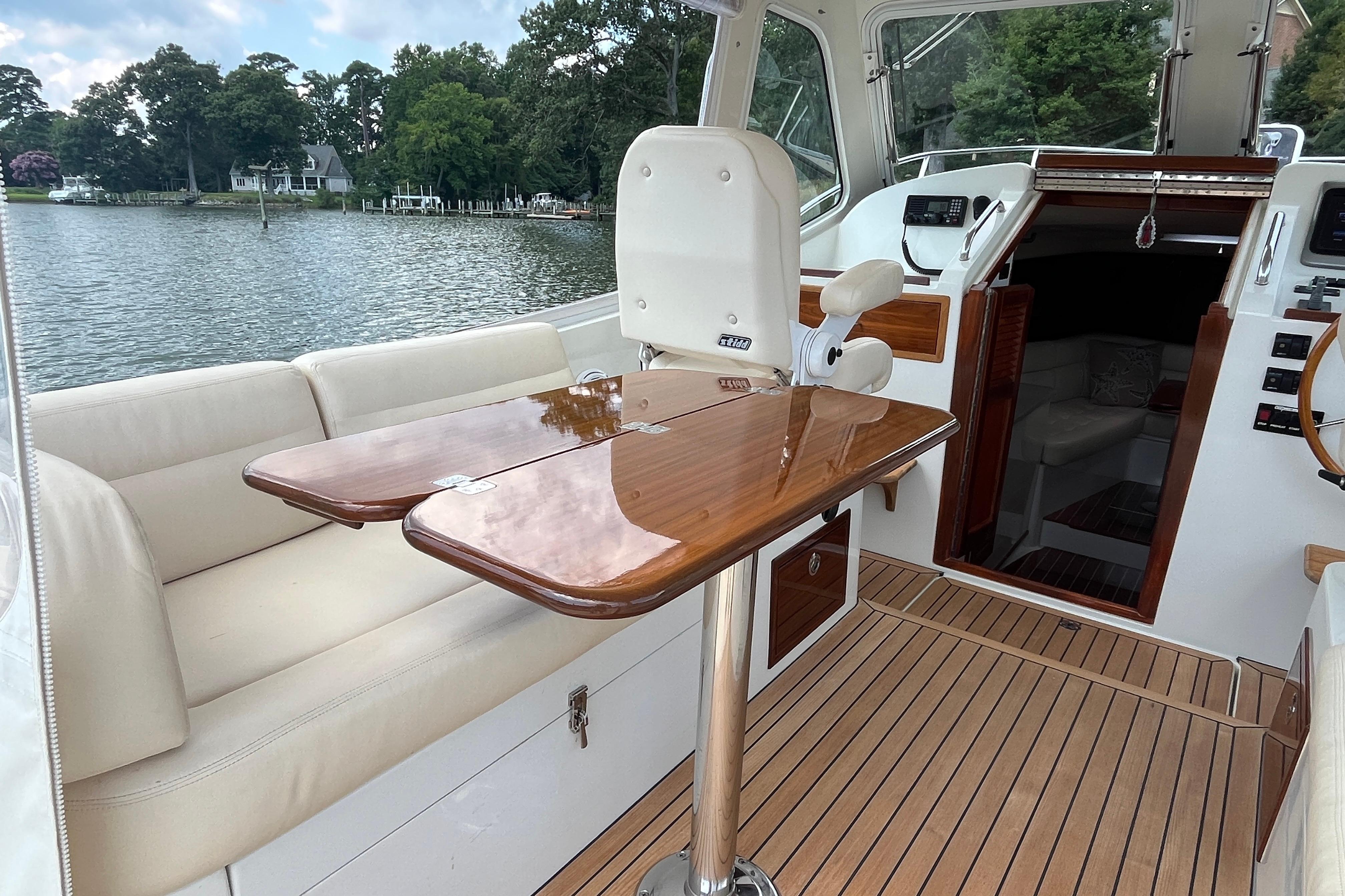 Luxurious 2006 MJM 34z yacht interior with wooden table and comfortable seating.