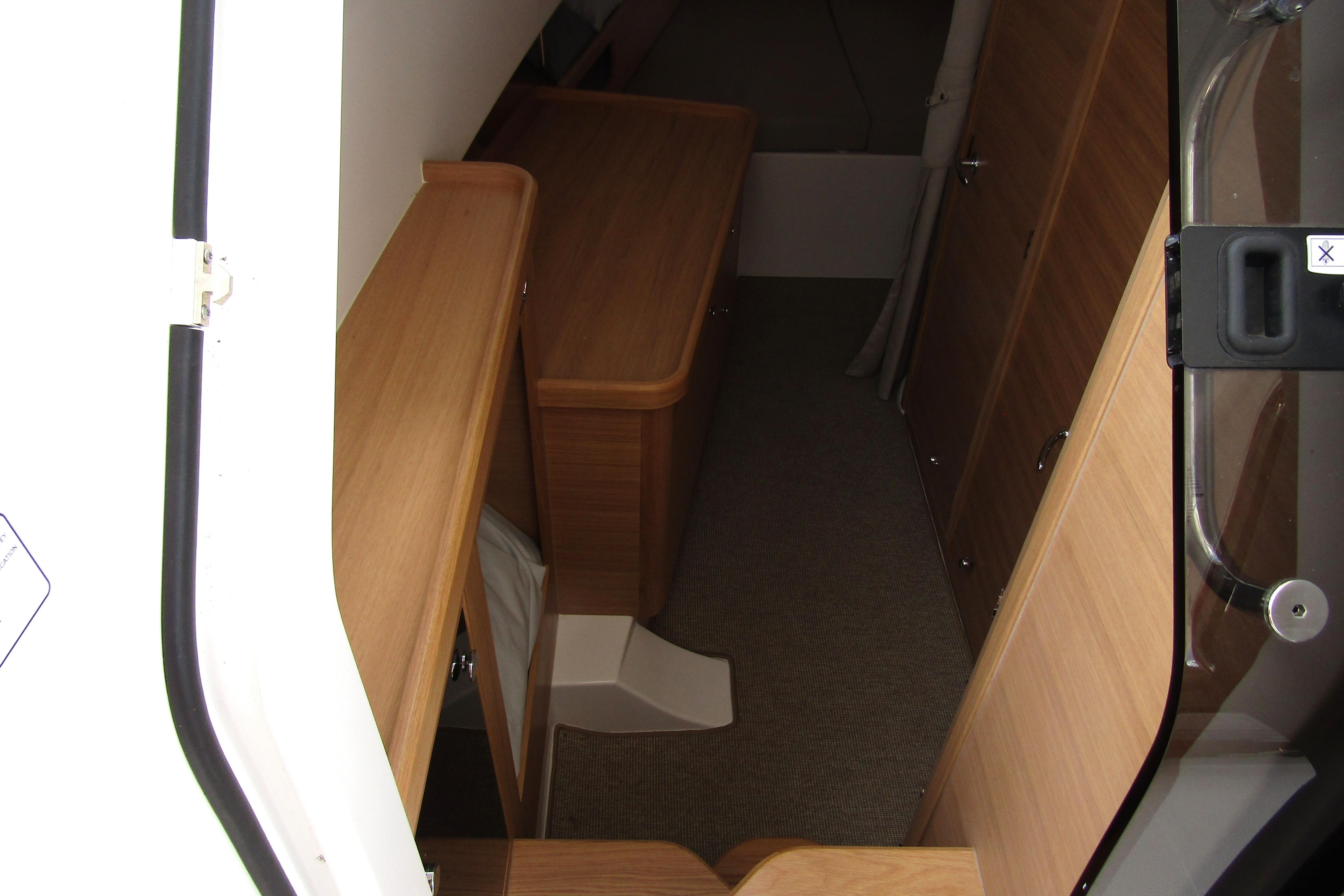 Interior view of 2025 Nimbus Tender 11, featuring wooden cabinetry and carpeted flooring.
