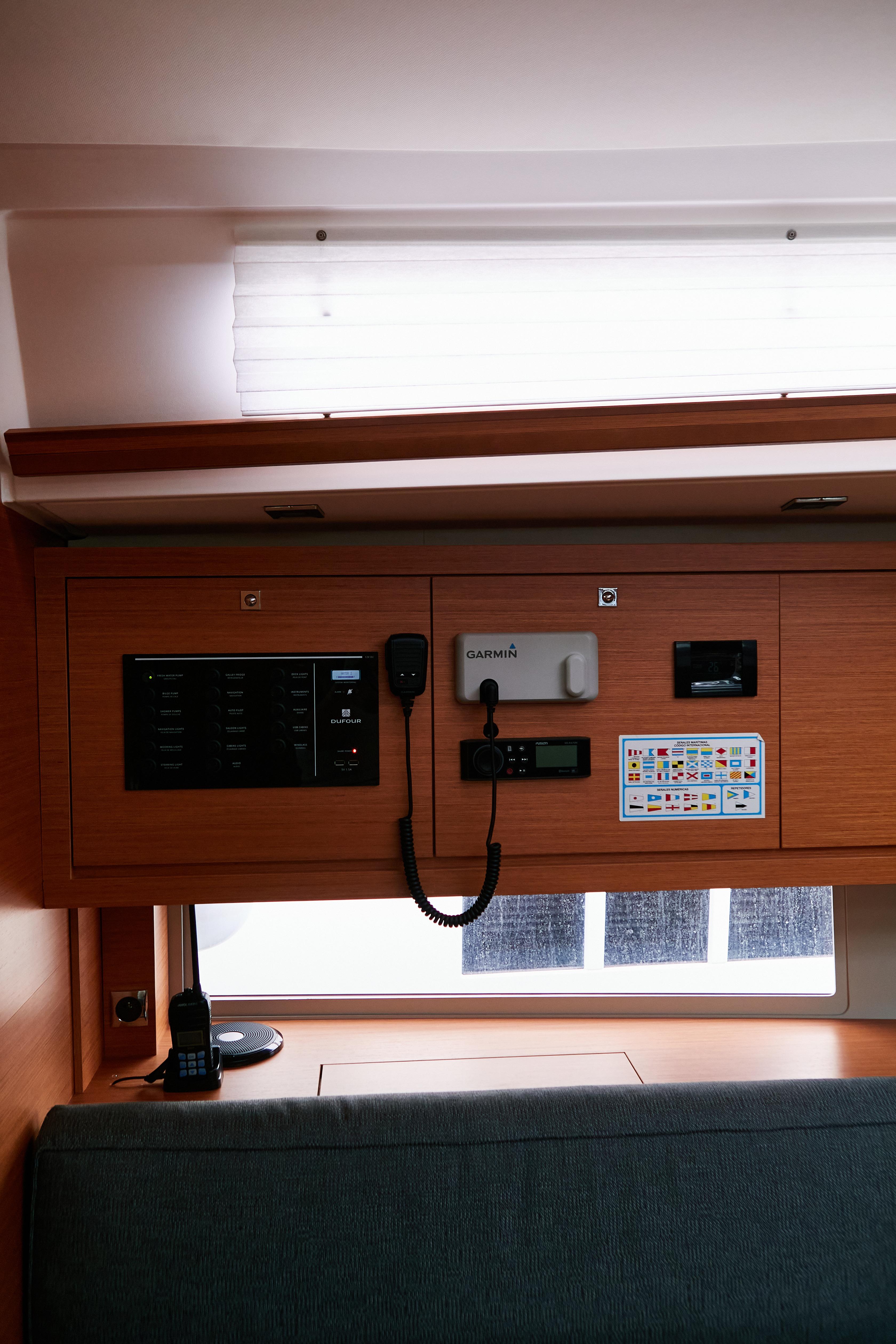 2023 Dufour 470 yacht interior control panel with modern navigation equipment.