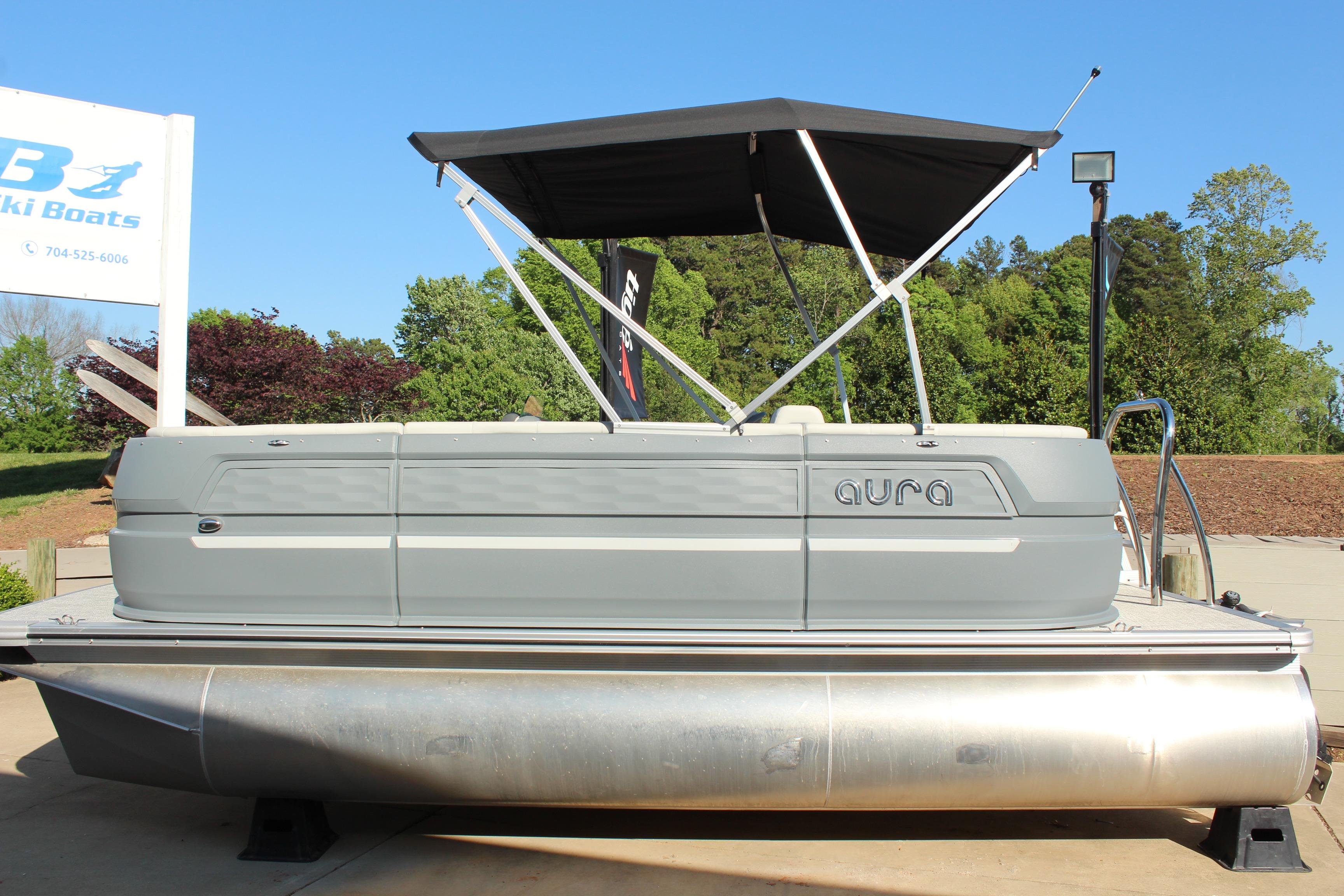 2026 Tahoe Pontoon Aura boat with canopy, displayed outdoors on a sunny day.