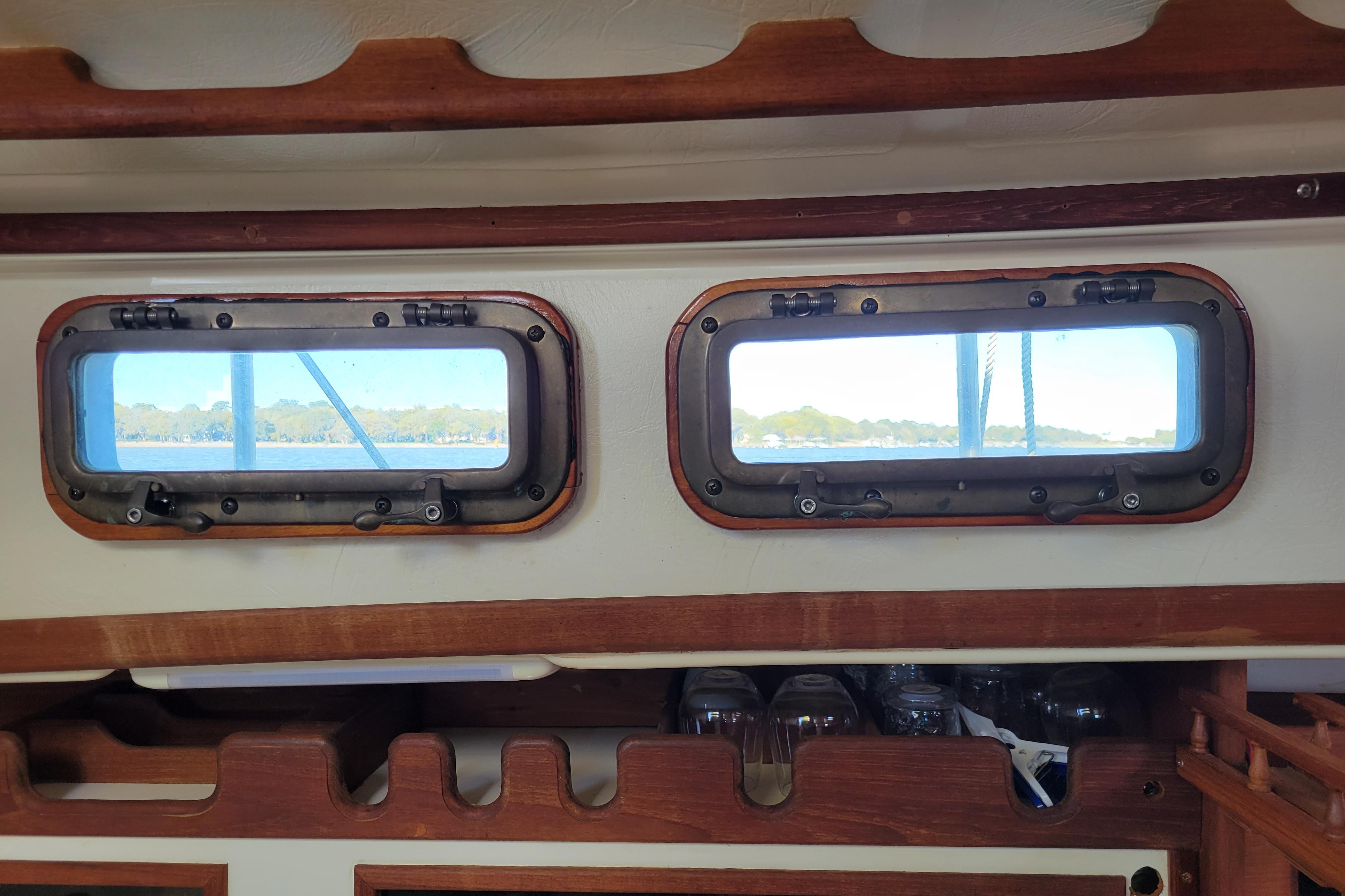 Interior view of 1981 Sea Sprite 34 sailboat with wooden trim and portholes.